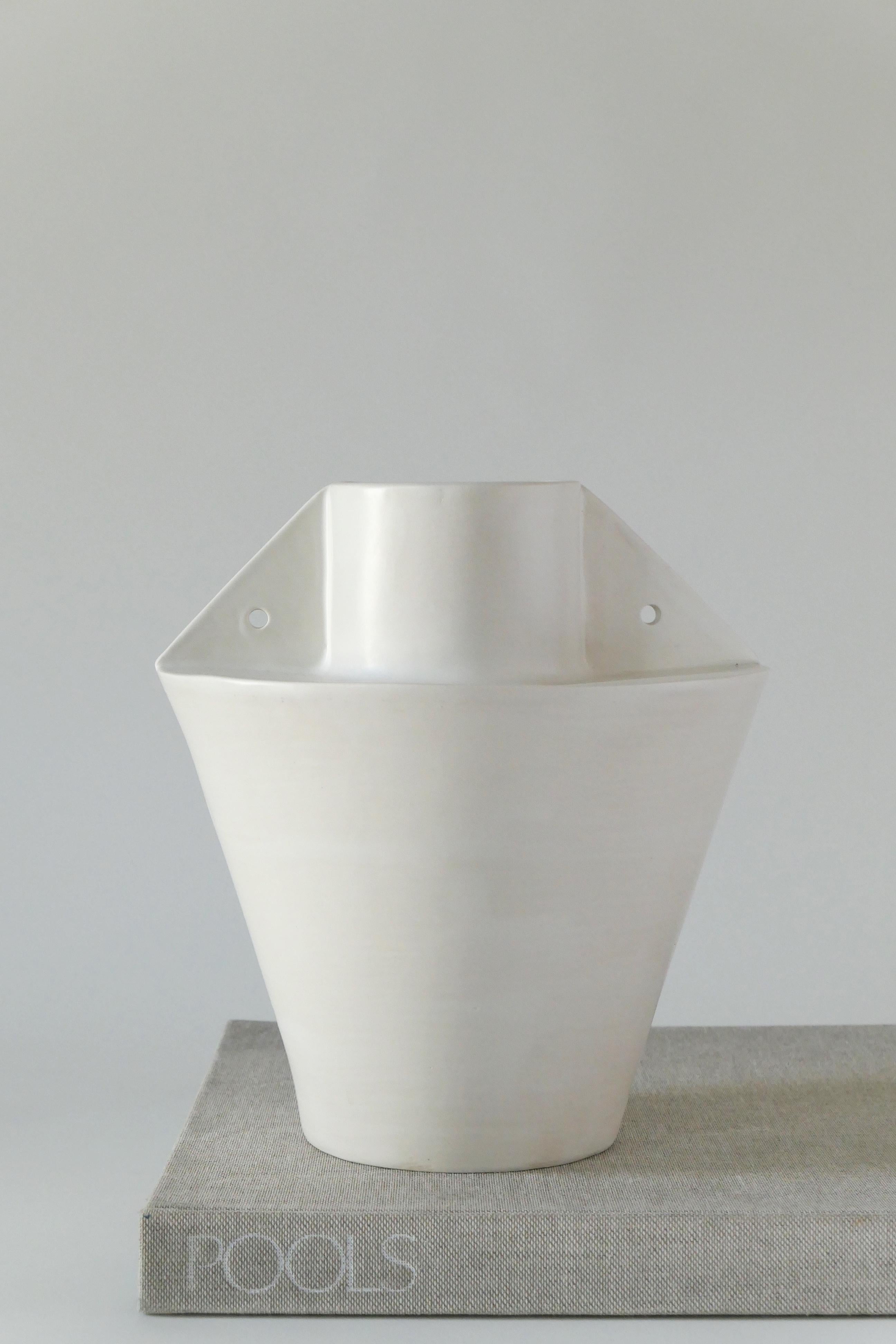 White stoneware vase, finished with a soft, white glaze. This vase is built buy hand using clay slabs.

Karina Vieira is a Brooklyn-based ceramicist focusing on handbuilt vessels. 

Her work references various styles, touching on the