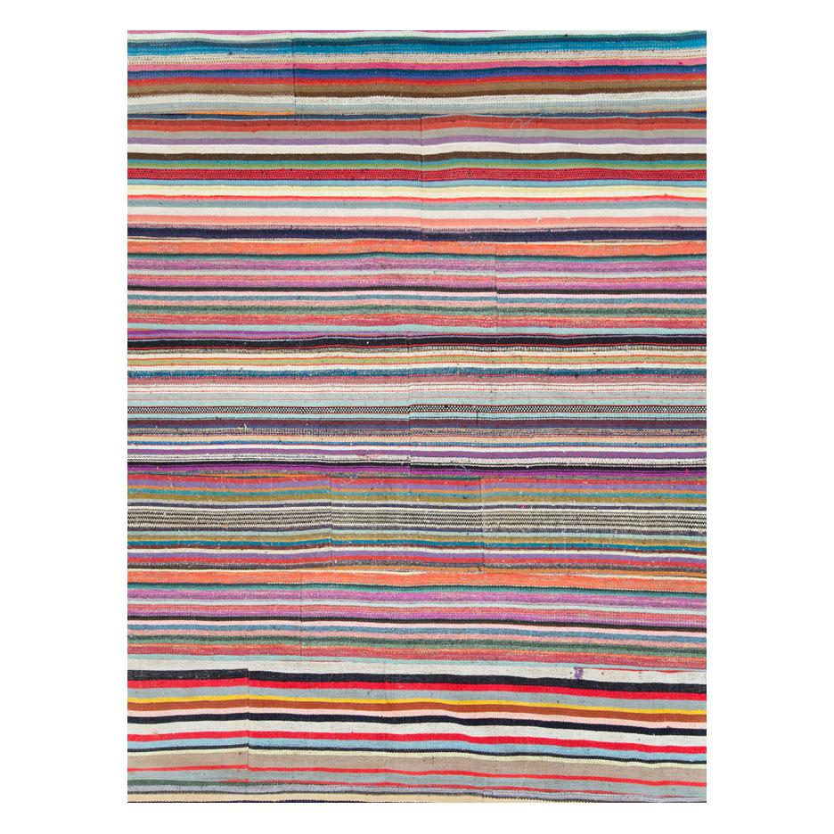 A modern Turkish oversize 16' x 19' flat-weave Kilim rug in square rug format handmade during the 21st century. A statement piece with its bright and whimsical colors.

Measures: 15' 10