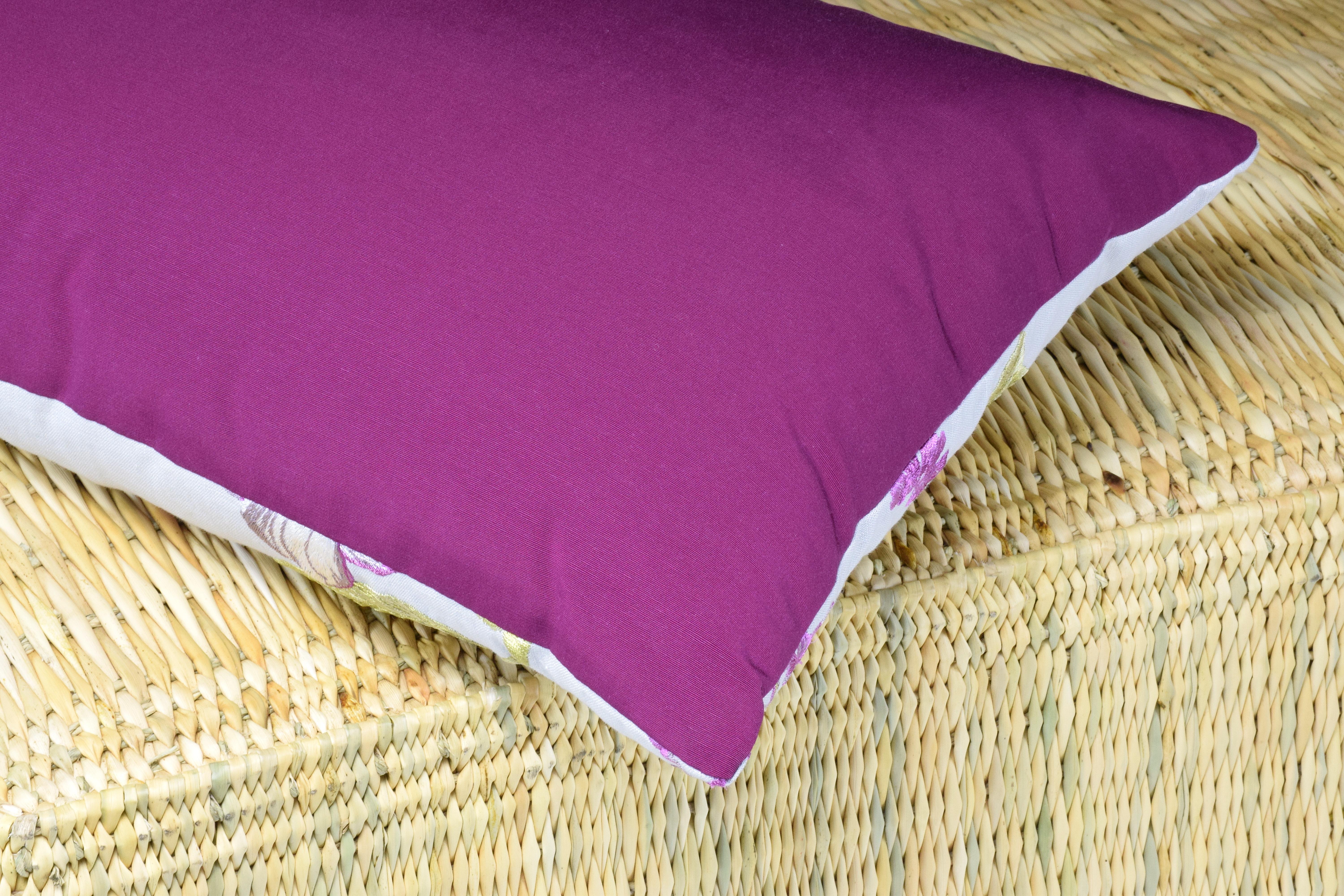 A designer's fabric rectangular cushion made with original French linen fabric. Its floral hand-embroidered patterns, in a vibrant palette of purple and green colors, is with no doubt an enchanting mood setter. The back-side is made of cotton and