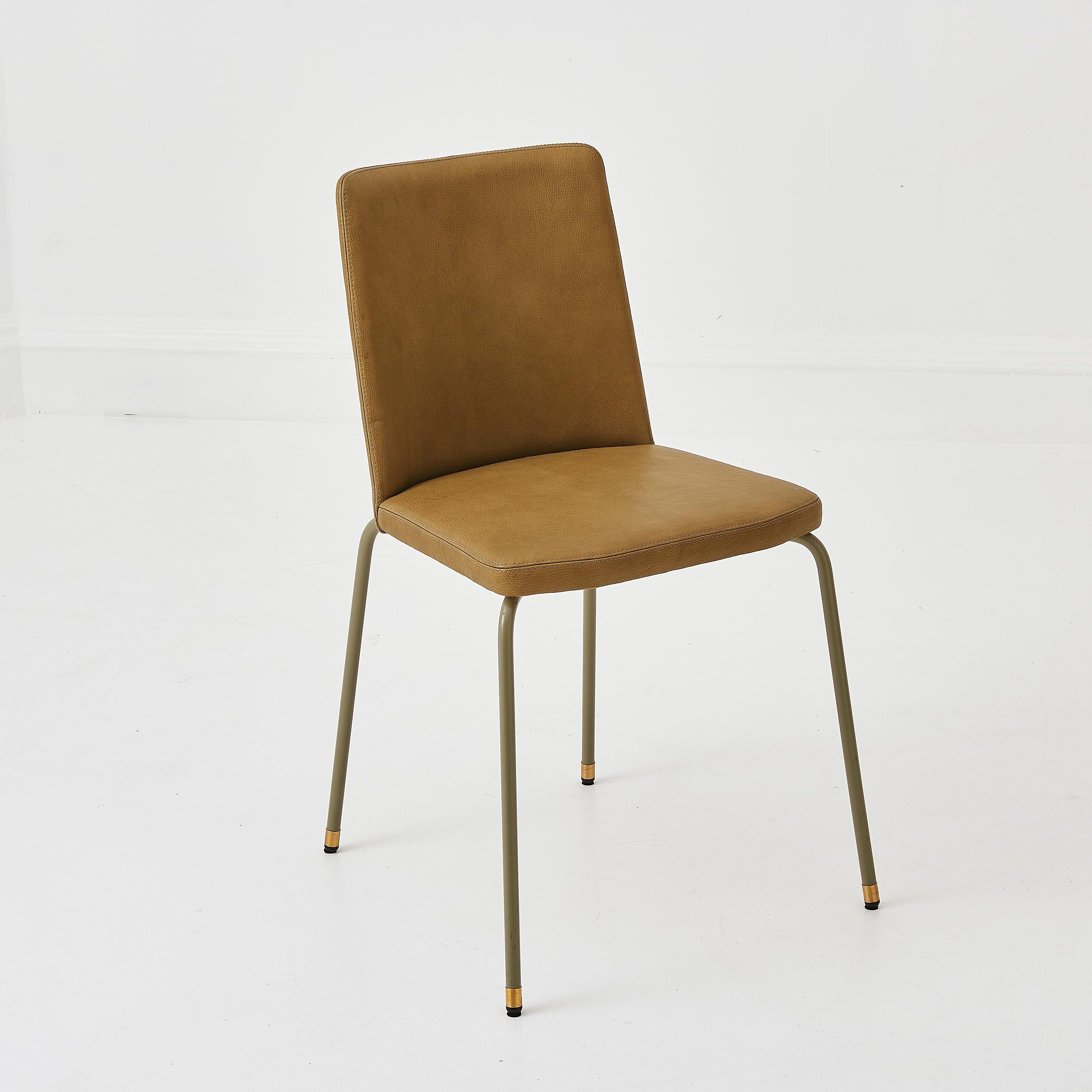 A stunning bespoke made in the UK contemporary green leather chair. 
Featuring brass accents and brass feet .
The green leather upholstery has matching green stitching, giving a seamless finish. 
With a wider backrest, it is very comfortable and