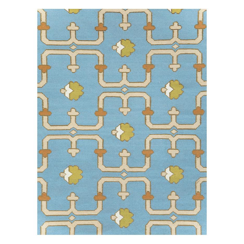 A modern Indian flat-weave Dhurrie room size carpet handmade during the 21st century with a light blue field and border.

Measures: 9' 2