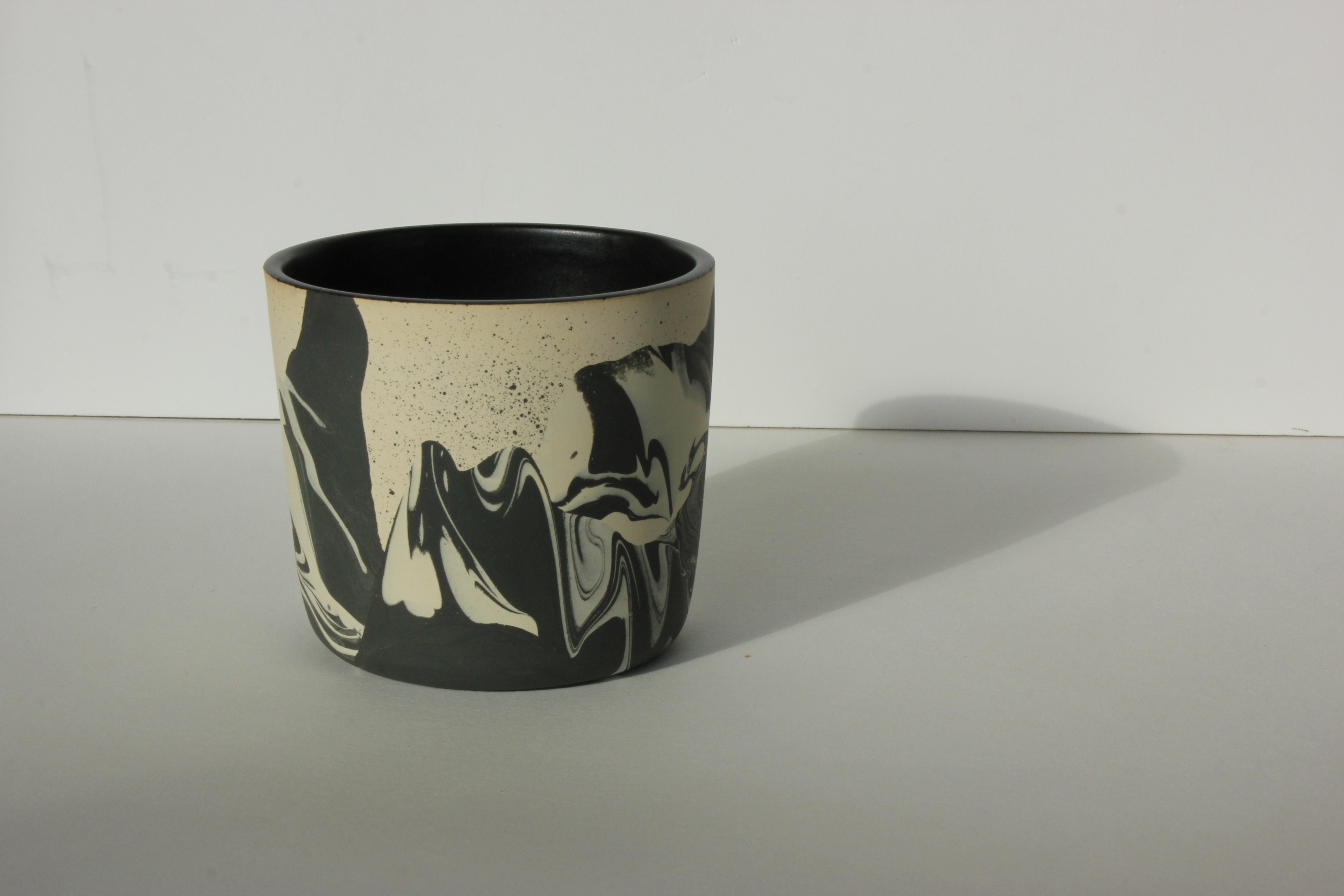 Handmade ceramic stoneware cup. Marbled raw colored clay exterior with satin black glaze interior. Available in other options. Handmade by Malka Dina in Brooklyn, NY.
Due to the handmade nature of this item, each piece will be slightly unique and
