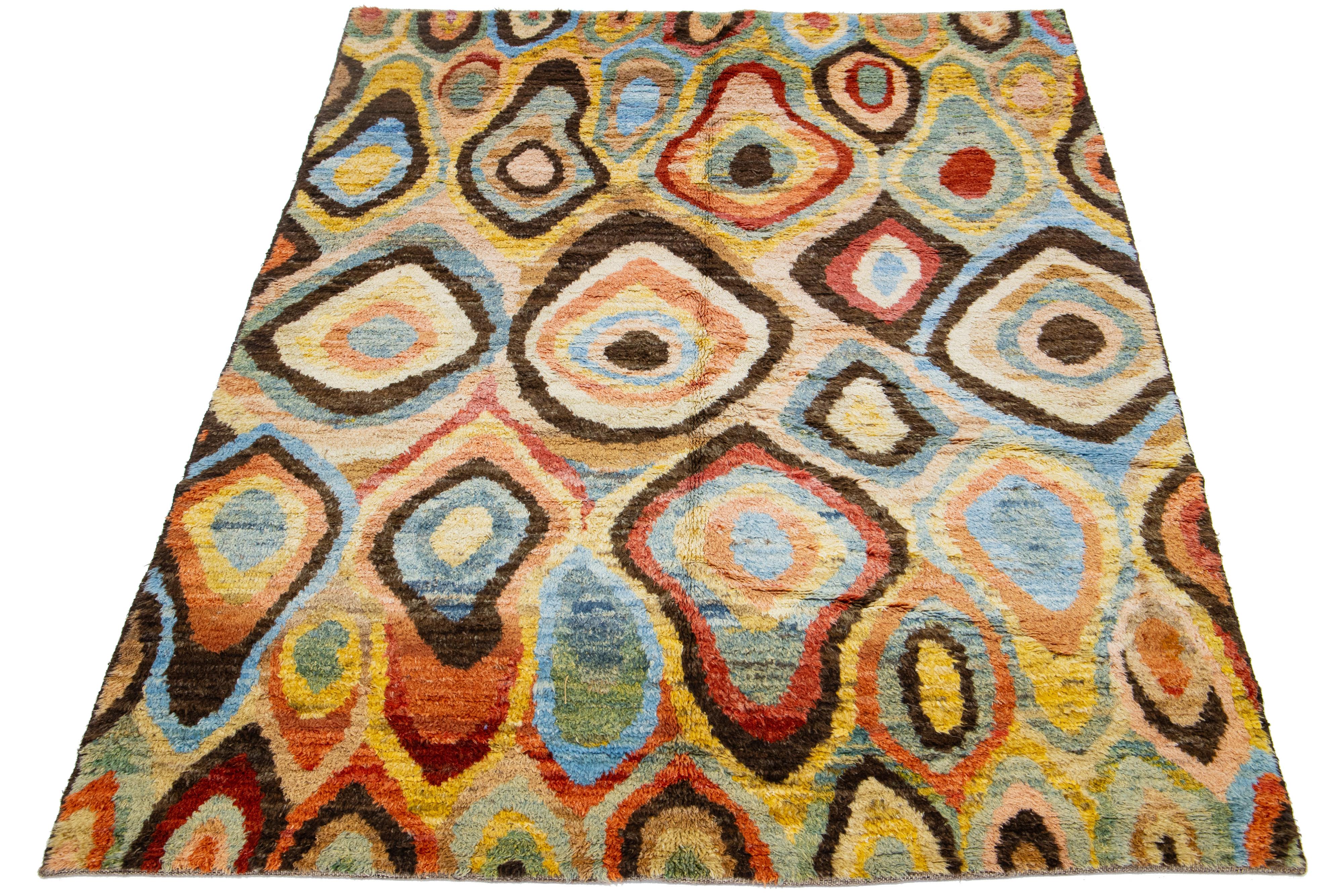 This beautiful, modern Moroccan-style, hand-knotted wool rug features a multicolor field. Highlights a stunning, soft, geometric design.

This rug measures 6'2