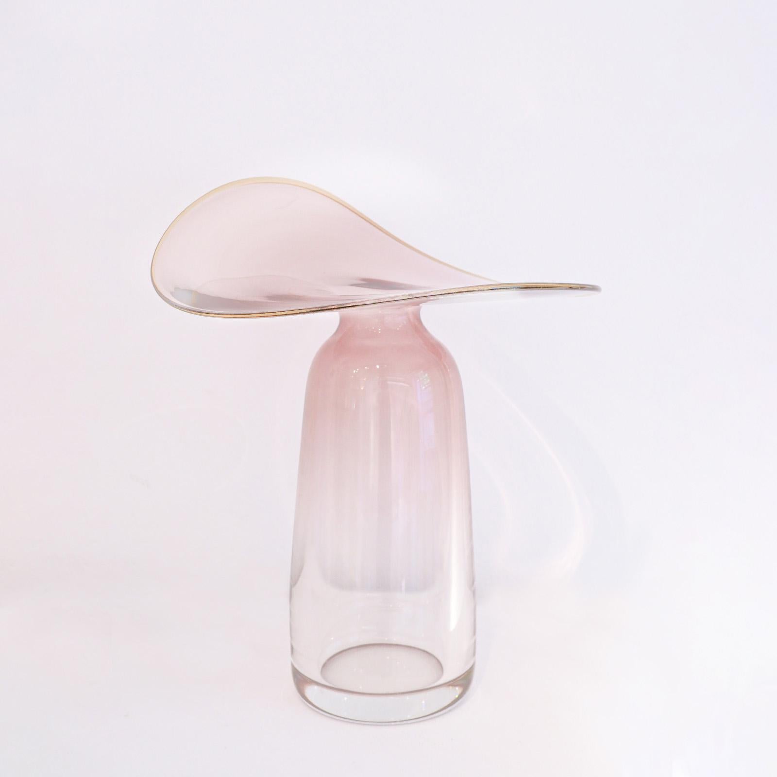 “Auris” is a trilogy of blown glass vases, each piece is inspired by the concept of listening, featuring shapes that open like parabolas, designed to receive and amplify sound. The glass, shaped through centrifugal force, creates large, delicate