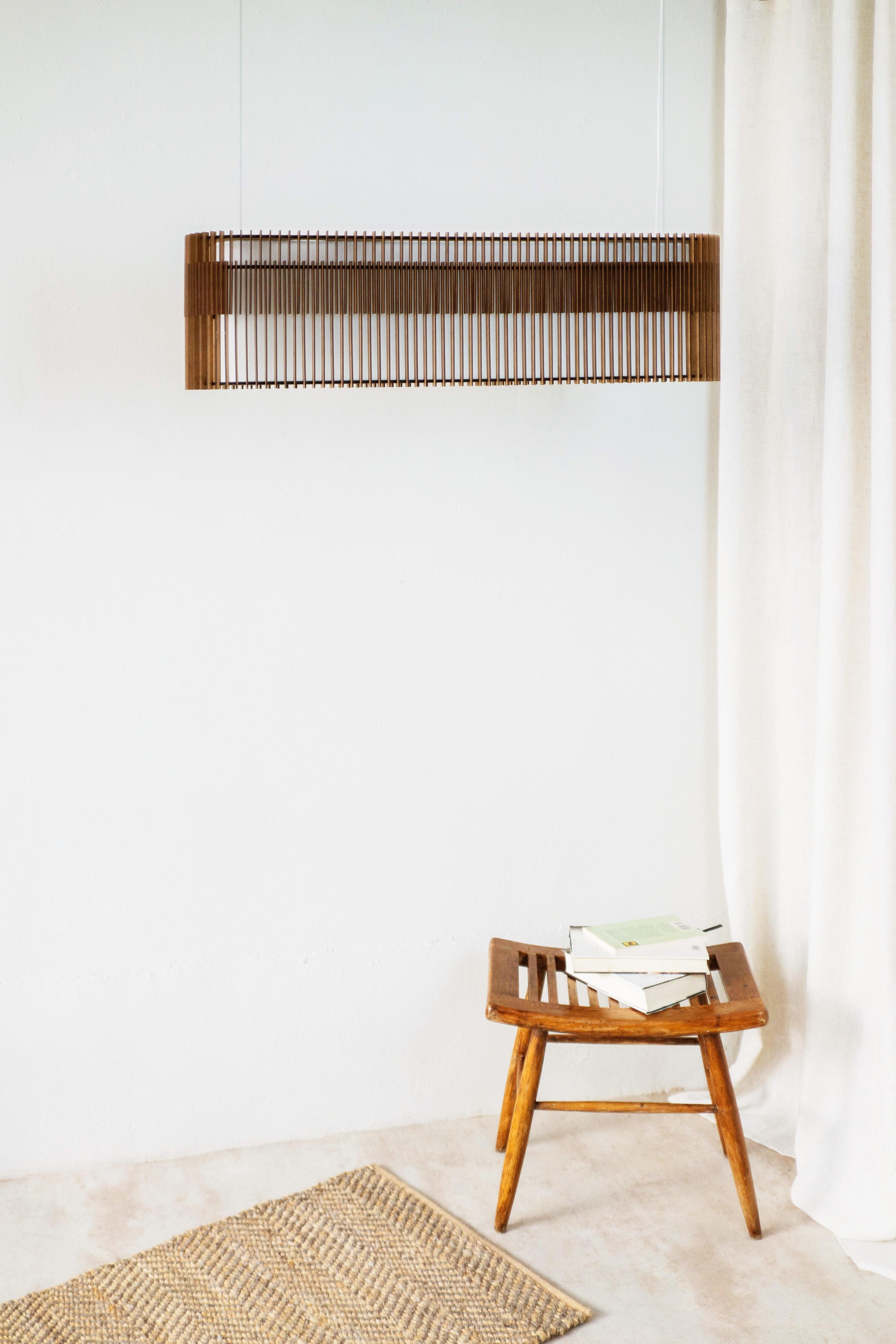 SUAU lamps are designed and manufactured by Mediterranean Objects in Barcelona, Spain. 
They have an outer lampshade made of MDF wooden slats, laser cut and assembled one by one, creating two different visual textures, one more dense and the other