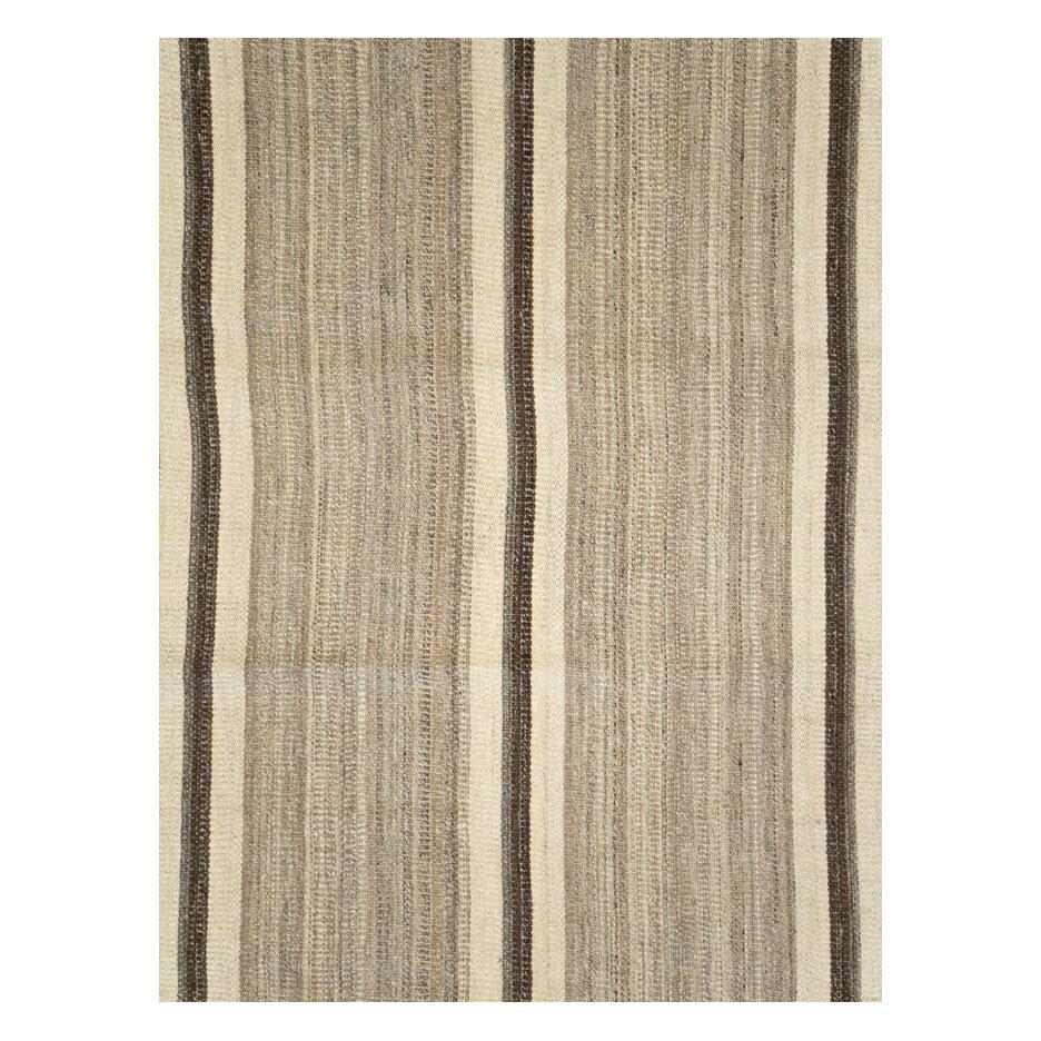 A modern Persian 12' x 14' flat-weave rug handmade during the 21st century inspired by vintage Kilim rugs woven by the nomadic groups of Persia and Central Asia with dark brown vertical stripes and alternating beige/ivory and brown vertical