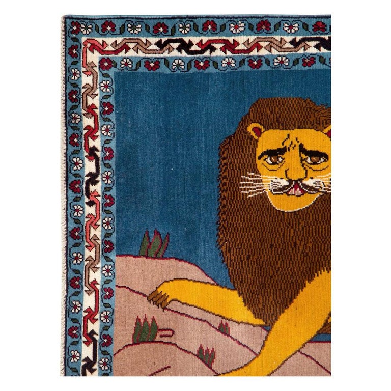 A modern Persian Shiraz small throw rug handmade during the 21st century with a pictorial design of a male lion in yellow over a blue background.

Measures: 3' 4