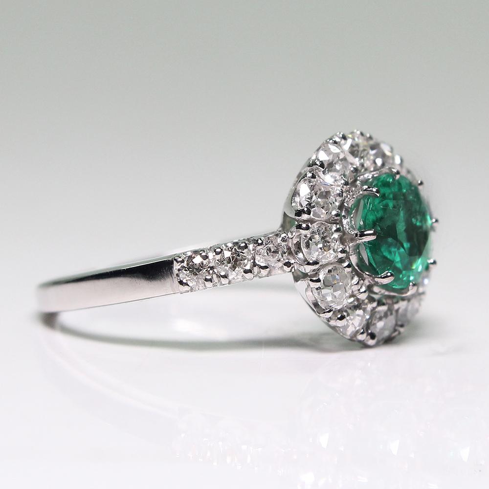 Composition: Platinum.

Stones:

•	1 natural Colombian Emerald that weighs 1.05ctw.
•	18 Old mine cut diamonds of H-VS2/SI1 quality that weigh 0.85ctw.

Ring face:  11mm by 11mm 
Rise above finger: 6mm.
Total weight:  4.7grams – 3dwt

This purchase