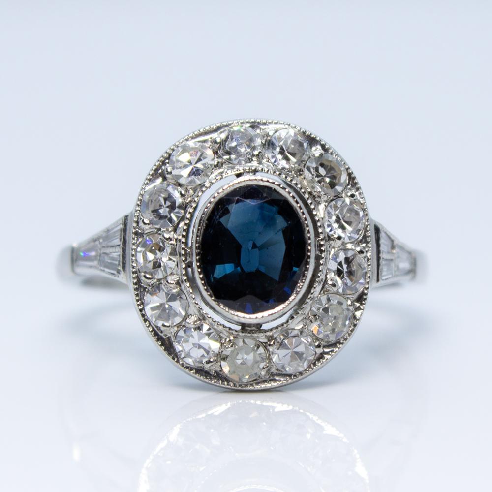 Composition: Platinum
Stones:
•	1 natural oval sapphire that weighs 1 carat weight.
•	14 Single cut diamonds of I-SI1 quality that weigh 0.40 carat weight. 
•	6 tupper cut diamonds of I-SI1 quality that weigh 0.20carat weight.
Ring size: 6   
Ring