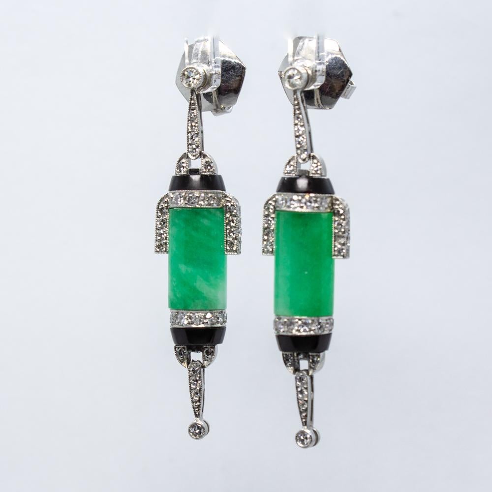 Composition: Platinum.
Stones:
•	2 natural Jades.
•	56 Single cut diamonds of I-VS2 that weigh 0.80ctw. 
Earrings measure: 46mm by 11mm 
Thick: 7mm
Total weight: 13.7grams – 8.8dwt 
This is an enchanting pair of earrings, especially designed for