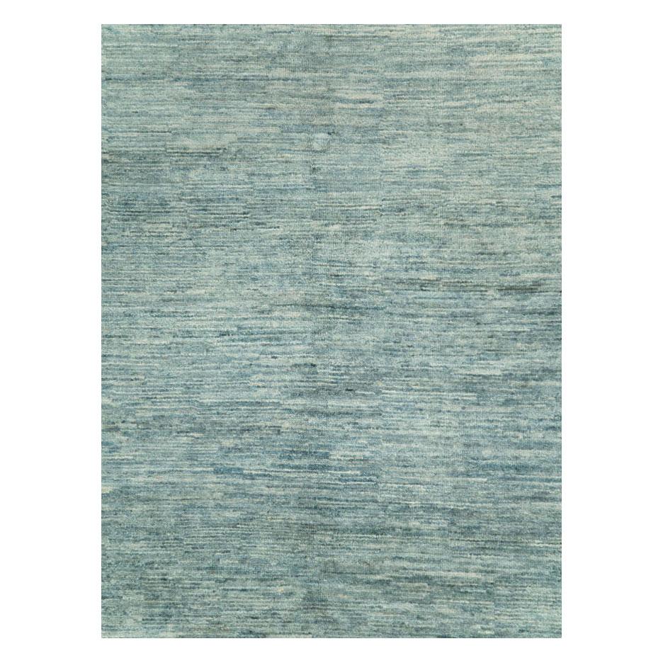 A modern Turkish room size carpet handmade during the 21st century with a solid pattern in variations of seafoam green.

Measures: 8' 0