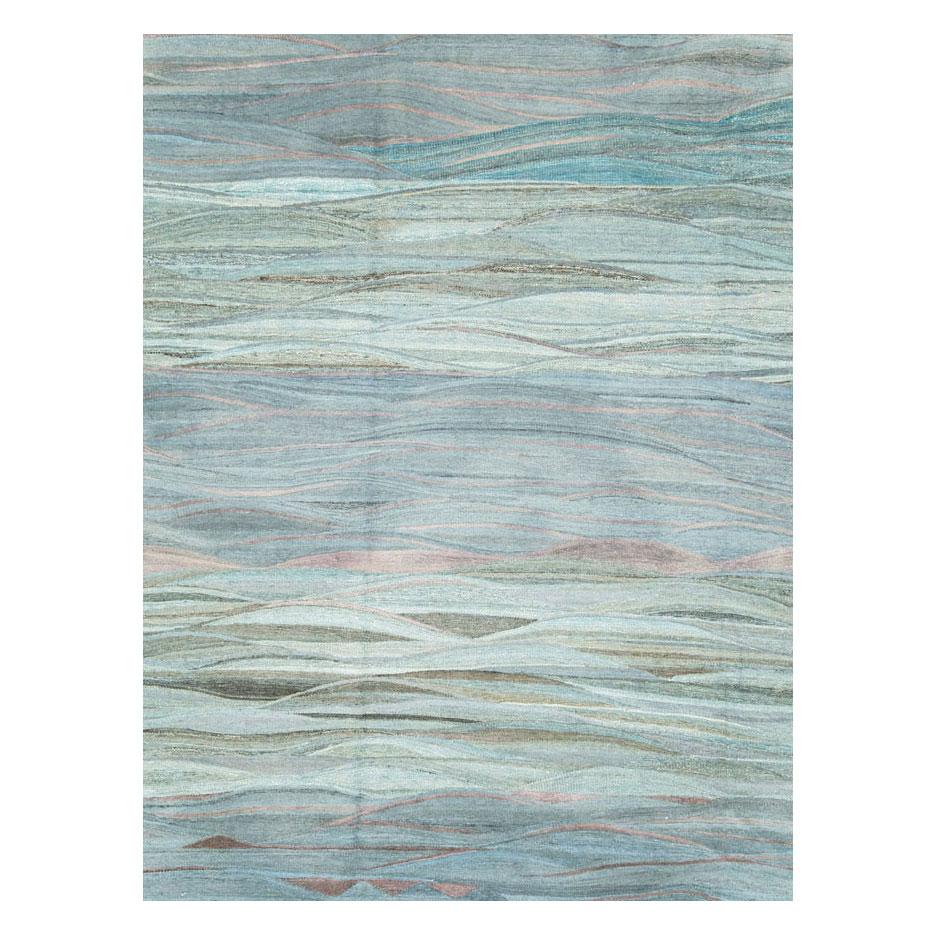 A modern Turkish flat-weave large 12' x 15' room size rug, inspired by Swedish and Scandinavian Kilims, handmade during the 21st century in various shades of blue and mauve.

Measures: 11' 7