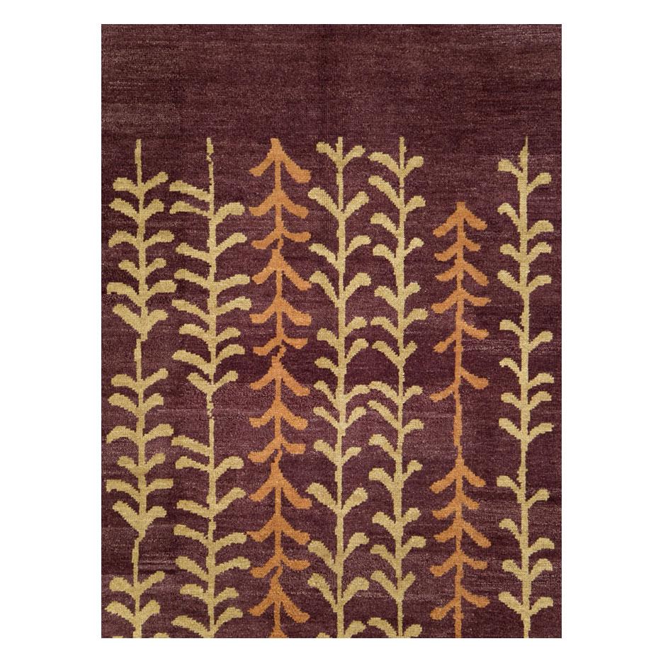 A modern Turkish Anatolian room size carpet handmade during the 21st century. This contemporary borderless Turkish rug features 7 leafy vines over an aubergine (eggplant) purple colored field.

Measures: 8'8