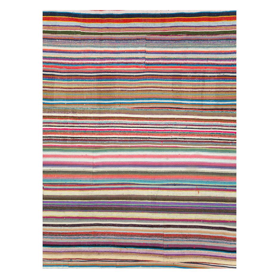 A modern Turkish flat-weave Kilim large, square format, room size carpet handmade during the 21st century with a colorful horizontally striped pattern. A statement piece with its bright and whimsical colors.

Measures: 14' 1