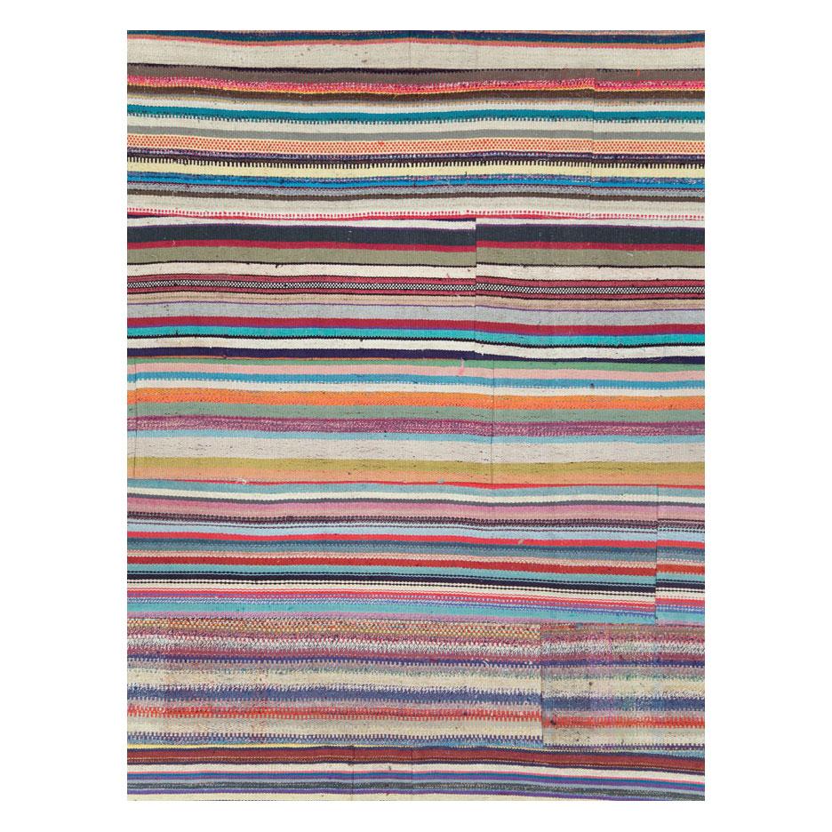 A modern Turkish flat-weave Kilim oversize carpet handmade during the 21st century with a colorful horizontal pattern. A statement piece with its bright and whimsical colors.

Measures: 12' 0