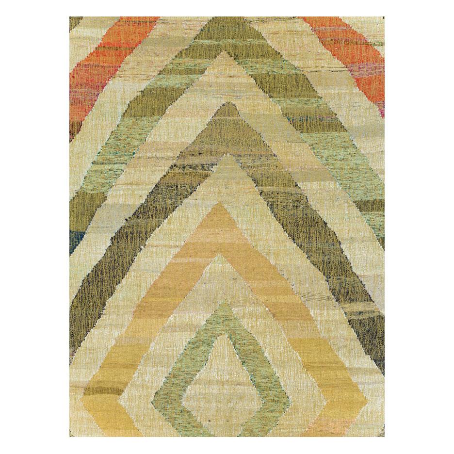 A modern Turkish flat-weave Kilim large room size carpet handmade during the 21st century with a geometric large scale diamond-shaped pattern in earth tones with an overall khaki green tonality.

Measures: 12' 5