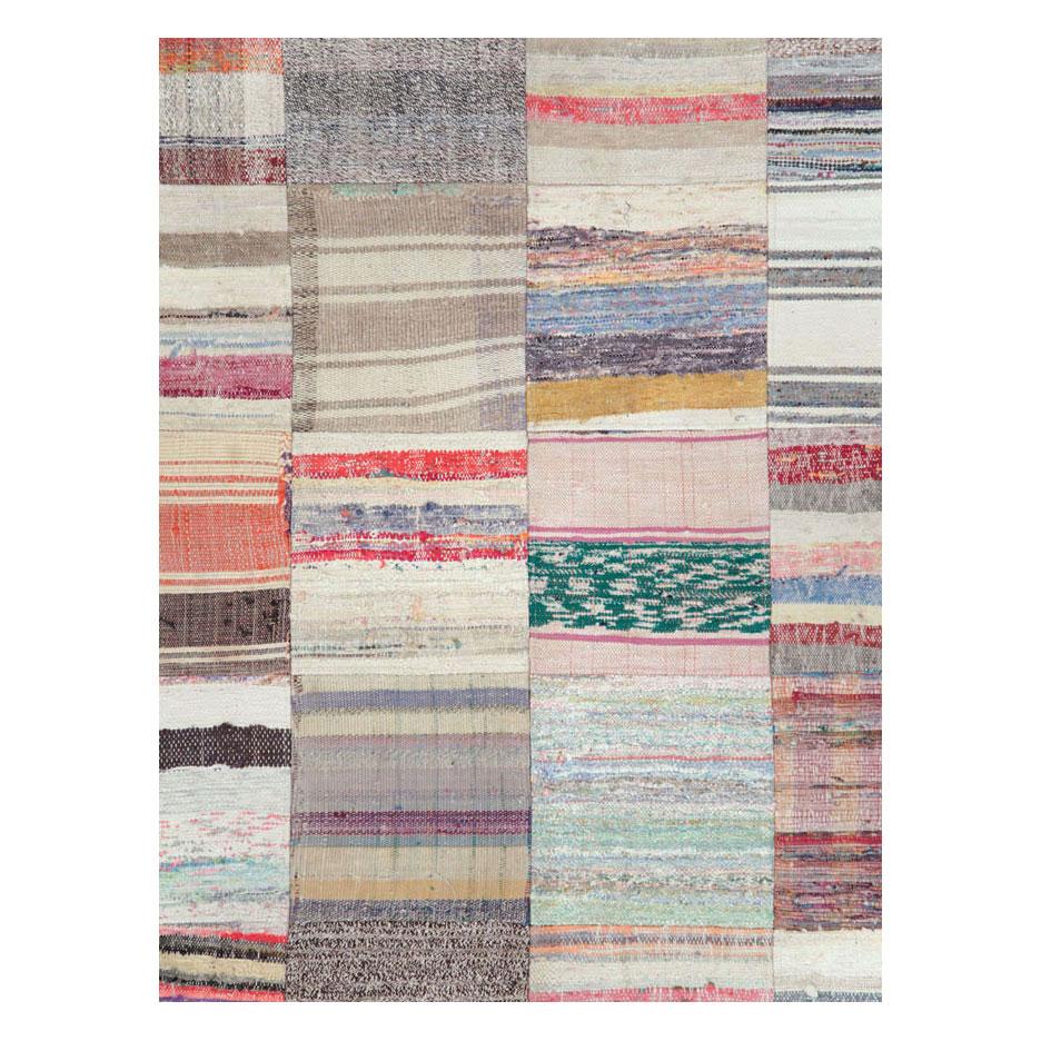 A modern Turkish flat-weave Kilim room size carpet handmade during the 21st century in a patchwork-like style with several square compartments of striped or plaid designs.

Measures: 10' 0