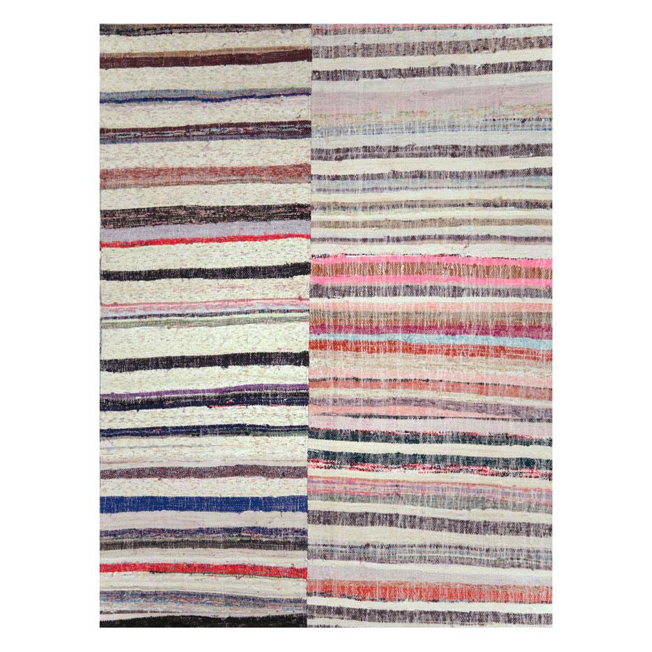 A modern Turkish flat-weave Kilim room size carpet handmade during the 21st century consisting of 4 vertical columns of stripes in colorful and whimsical tones.

Measures: 9'8