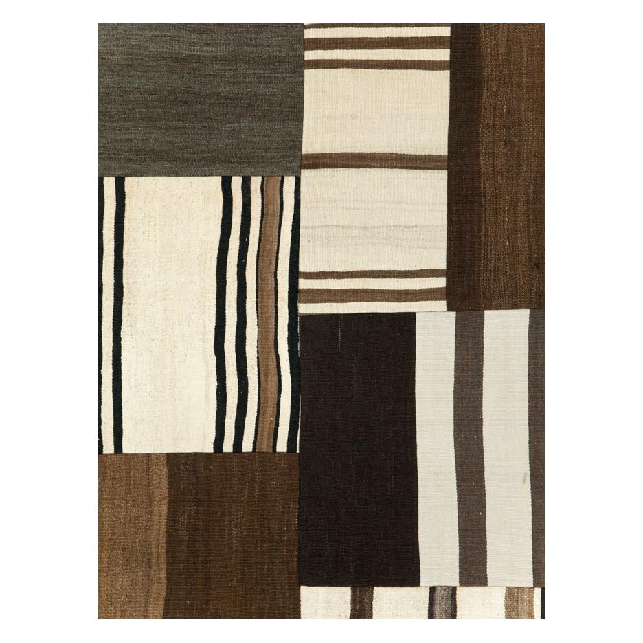 A contemporary Turkish flatweave Kilim accent rug handmade during the 21st century. This patchwork style carpet consists of hand-weaving together several remnants of vintage Kilim carpets from the mid-20th century period.

Measures: 6' 10