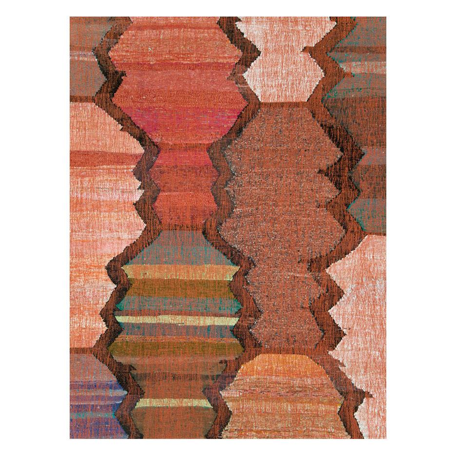 A modern Turkish flat-weave Kilim large room size carpet handmade during the 21st century with a colorful geometric pattern resembling interconnected serrated edged vases in an abstract form.

Measures: 12' 7