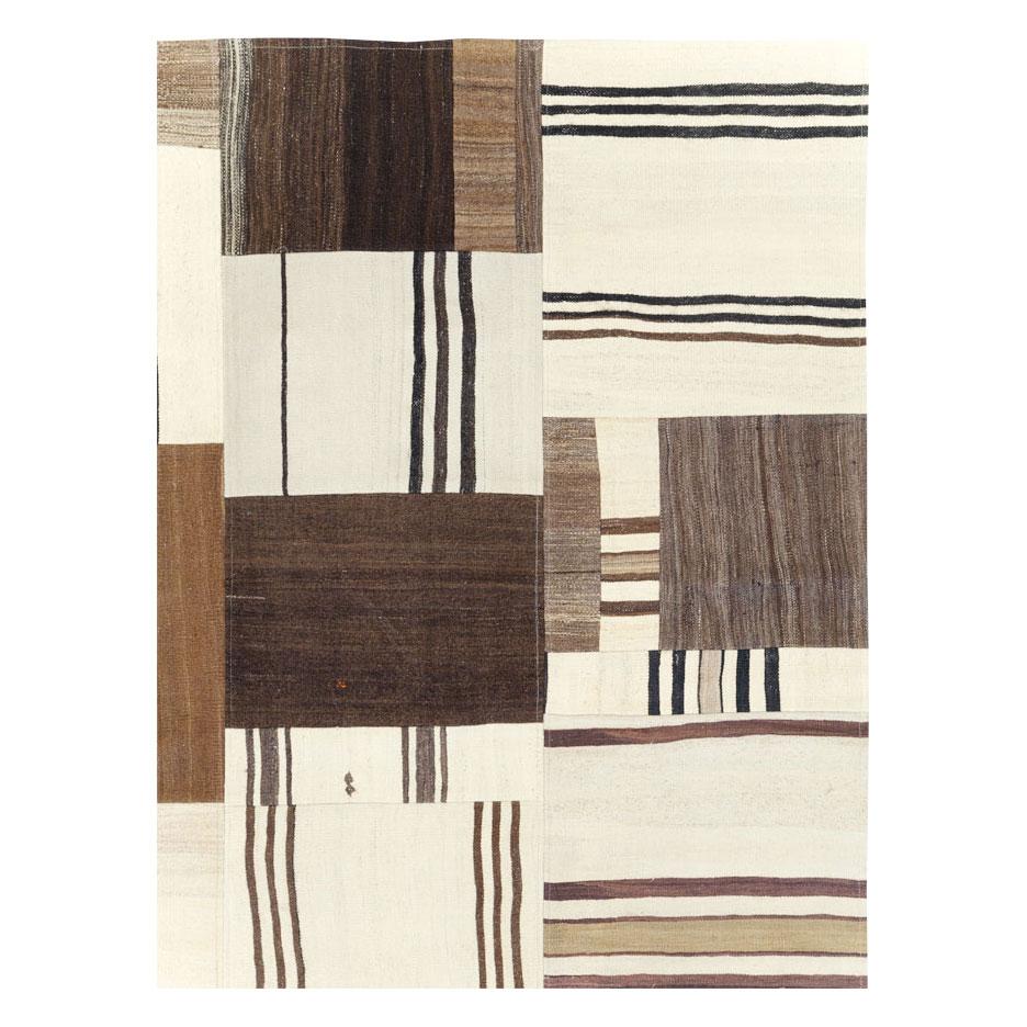 A modern Turkish flatweave Kilim patchwork style room size carpet handmade during the 21st century incorporating remnants of vintage Kilim rugs from the mid-20th century period.

Measures: 9' 2