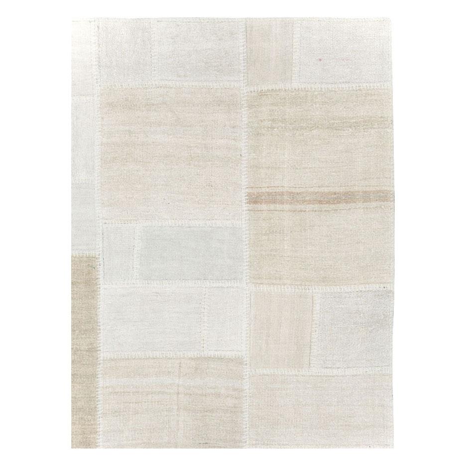 A modern Turkish patchwork-style flatweave Kilim room size carpet handmade during the 21st century using remnants of Turkish flatweaves from the mid-20th century period.

Measures: 9' 7