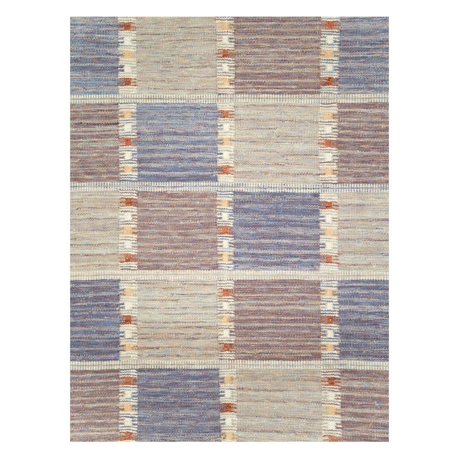 A modern Turkish Kilim flat-weave room size rug handmade during the 21st century with a geometric checkerboard design in pastel colors including blue, violet purple, cream, and coral.

Measures: 10' 3