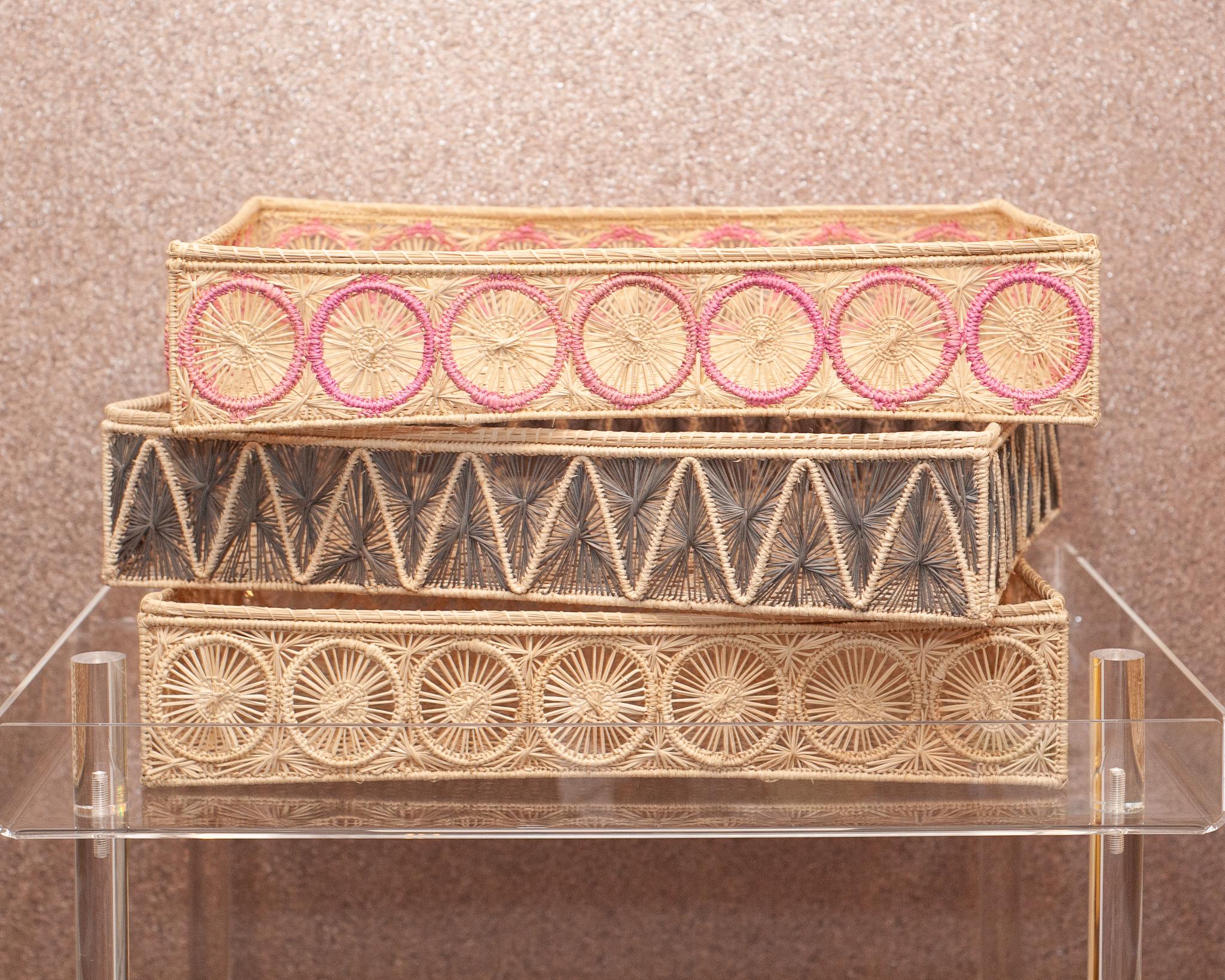 Uplift your table with these stunning handwoven rattan baskets / trays in natural and pink rattan. Finely crafted by expert artisans, these pieces all showcase the classical technique of weaving in a modern way. From Jean Michel Frank to the House