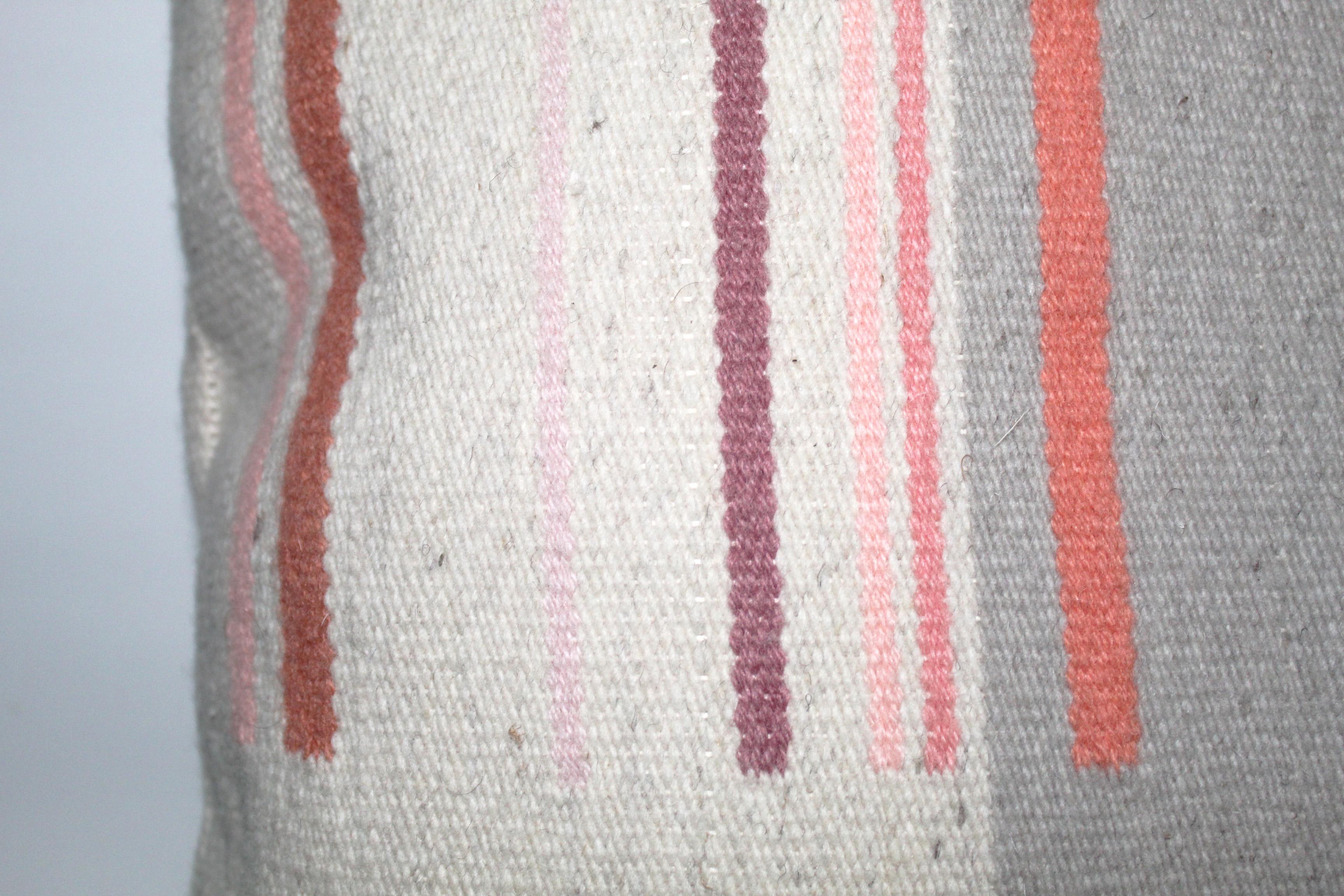 Contemporary handwoven wool throw pillow in pink and grey. 

Each color included in this pillow was hand-dyed with natural materials by the artist to achieve the subtle variety in tones. The shades of pink and salmon were created using Lac, a