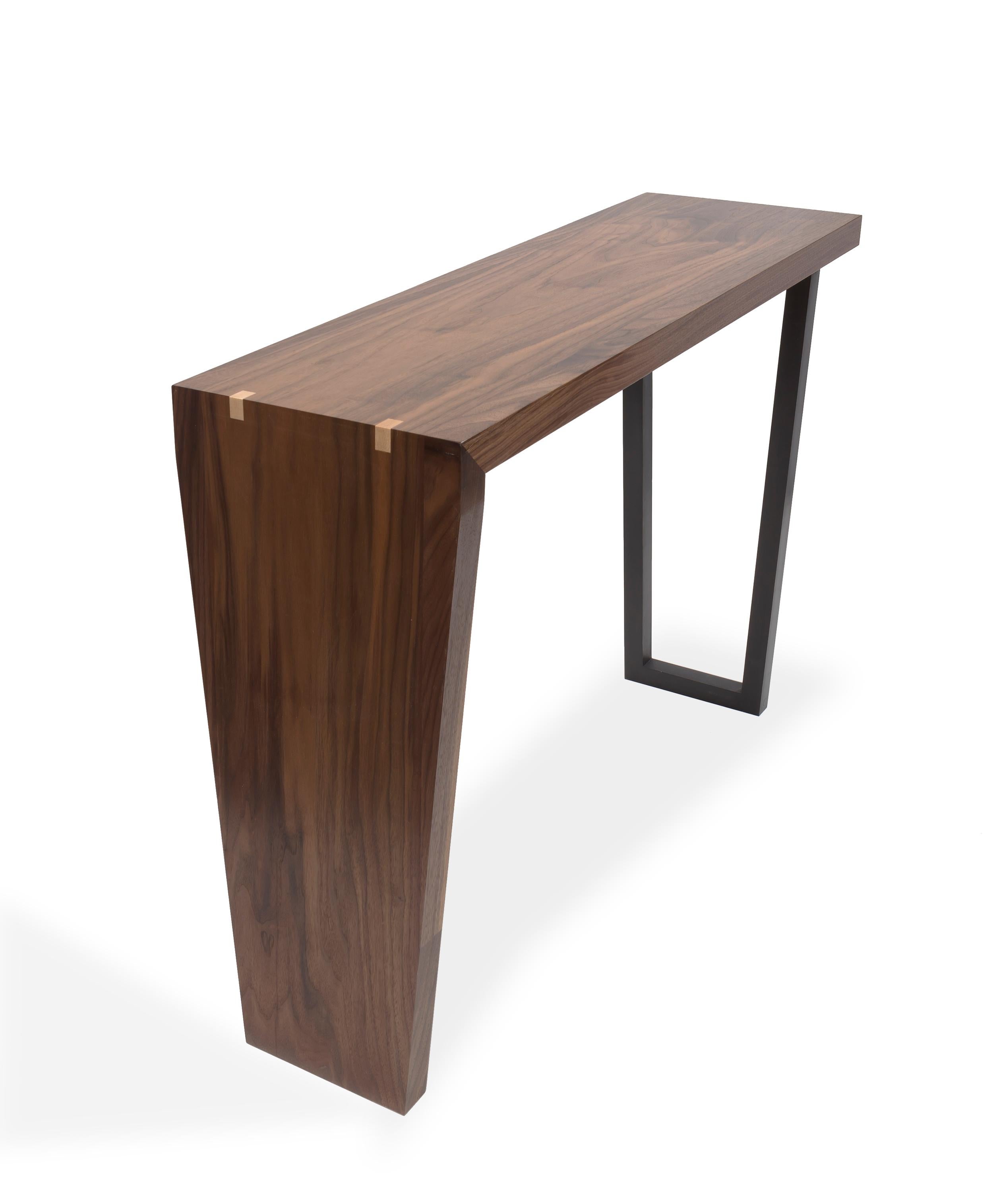 Walnut with teak detail and black lacquer legs.