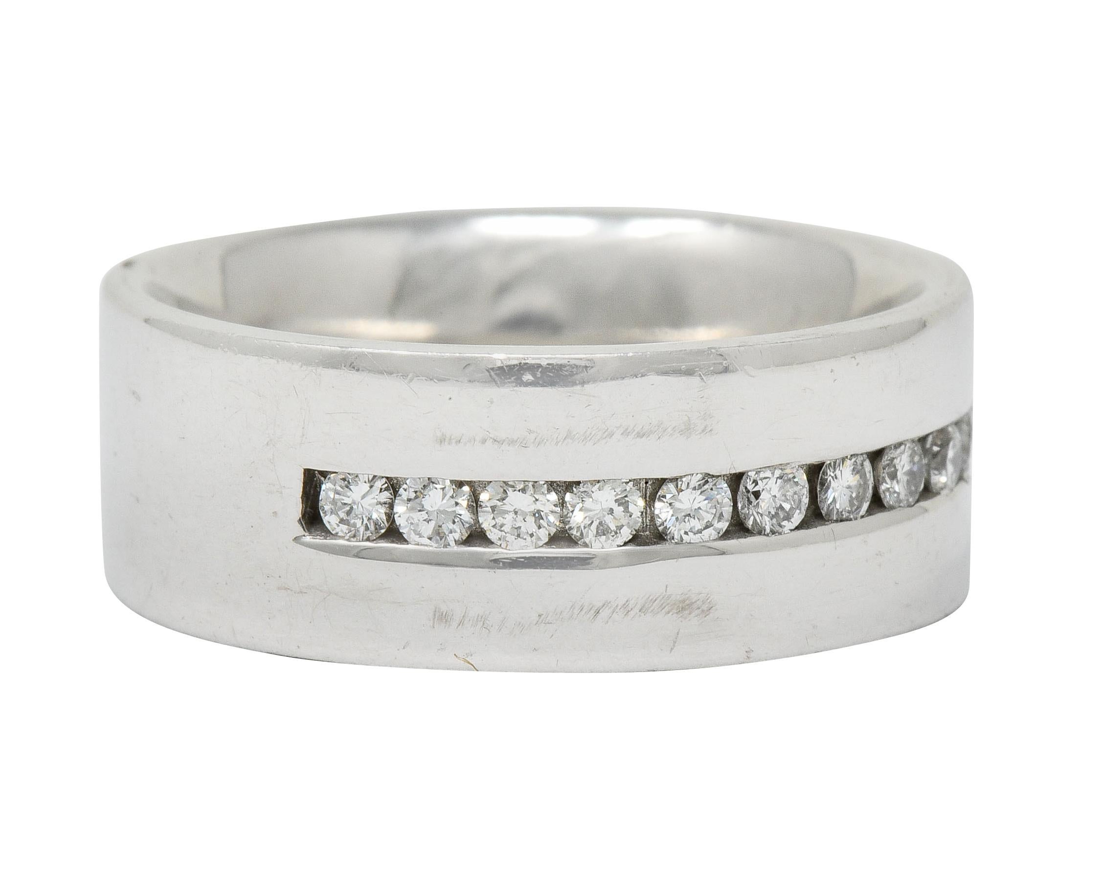 Wide band ring centering a channel of round brilliant cut diamonds

Weighing approximately 0.52 carat with G/H color and SI clarity

Channel is flanked by high polished white gold edges

Completed by a comfort fit grip

With maker's mark and stamped