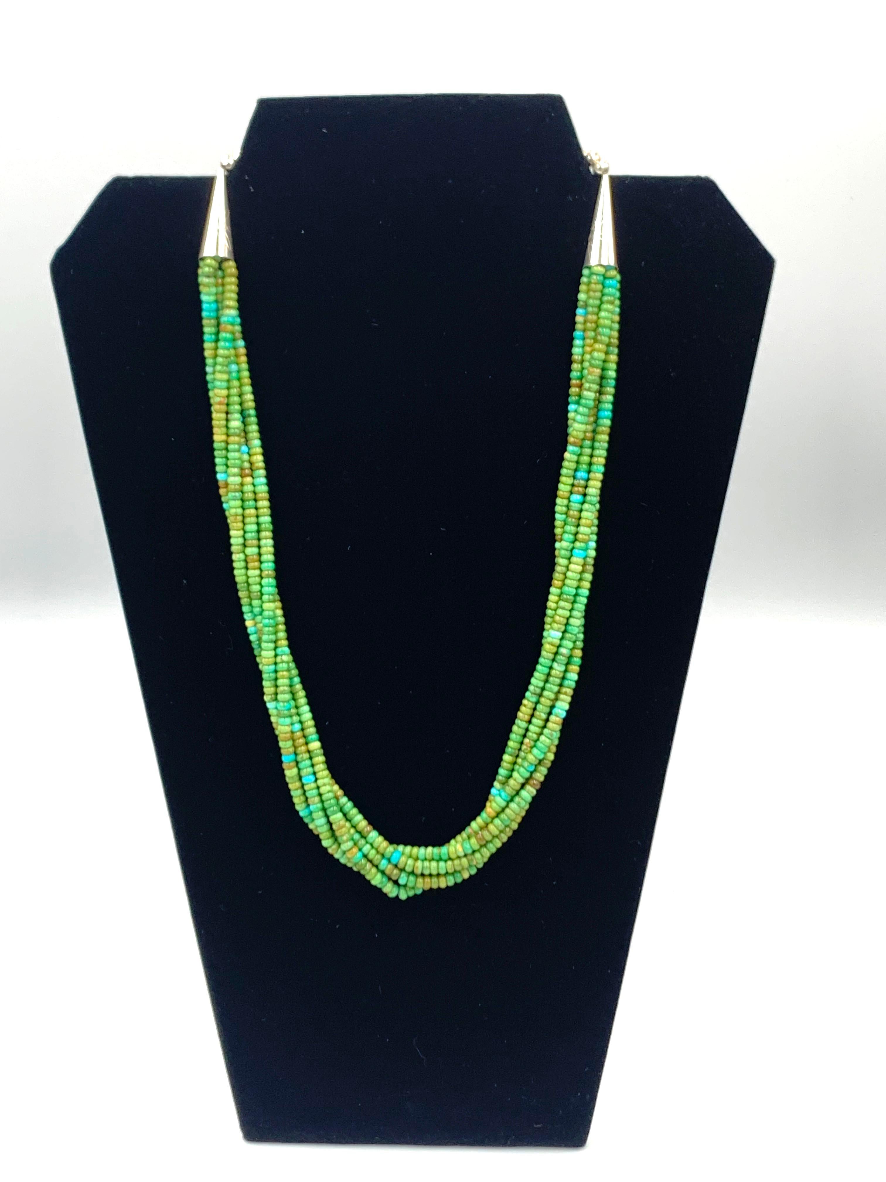 The 22.5” five strands of hand rolled Sonoran Gold turquoise beads necklace with silver cones and silver beads at both ends. 

Sonoran Gold Turquoise is mined in Sonora, Mexico near the city of Cananea. The mine is located at the Campitos Mountain