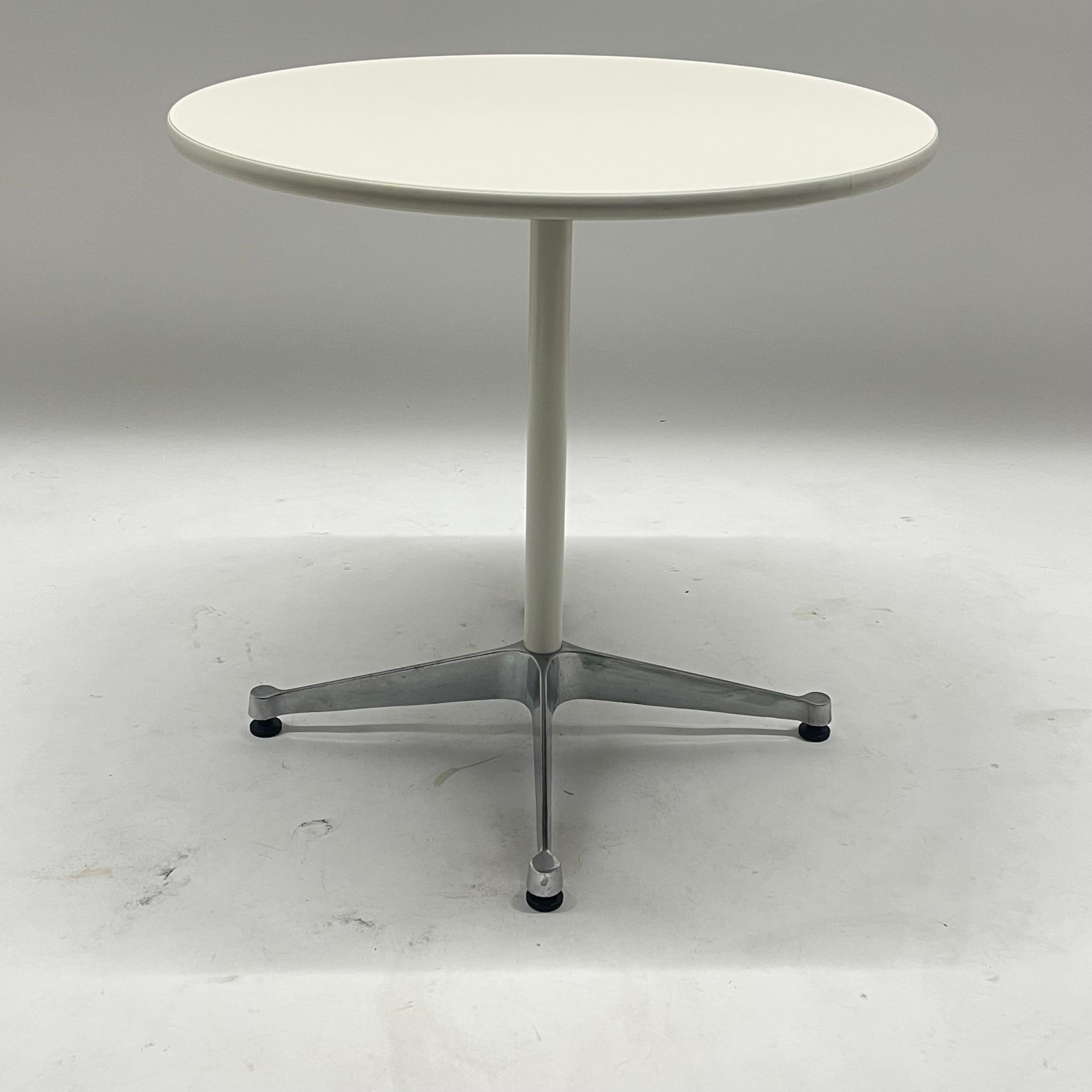 Contemporary Eames office dining, bistro, side, or end table. Rendered in durable white laminate wood top with a two tone aluminum and white powder coated base. This table has an extremely versatile size. By Eames for Herman Miller, USA, circa 2000s.