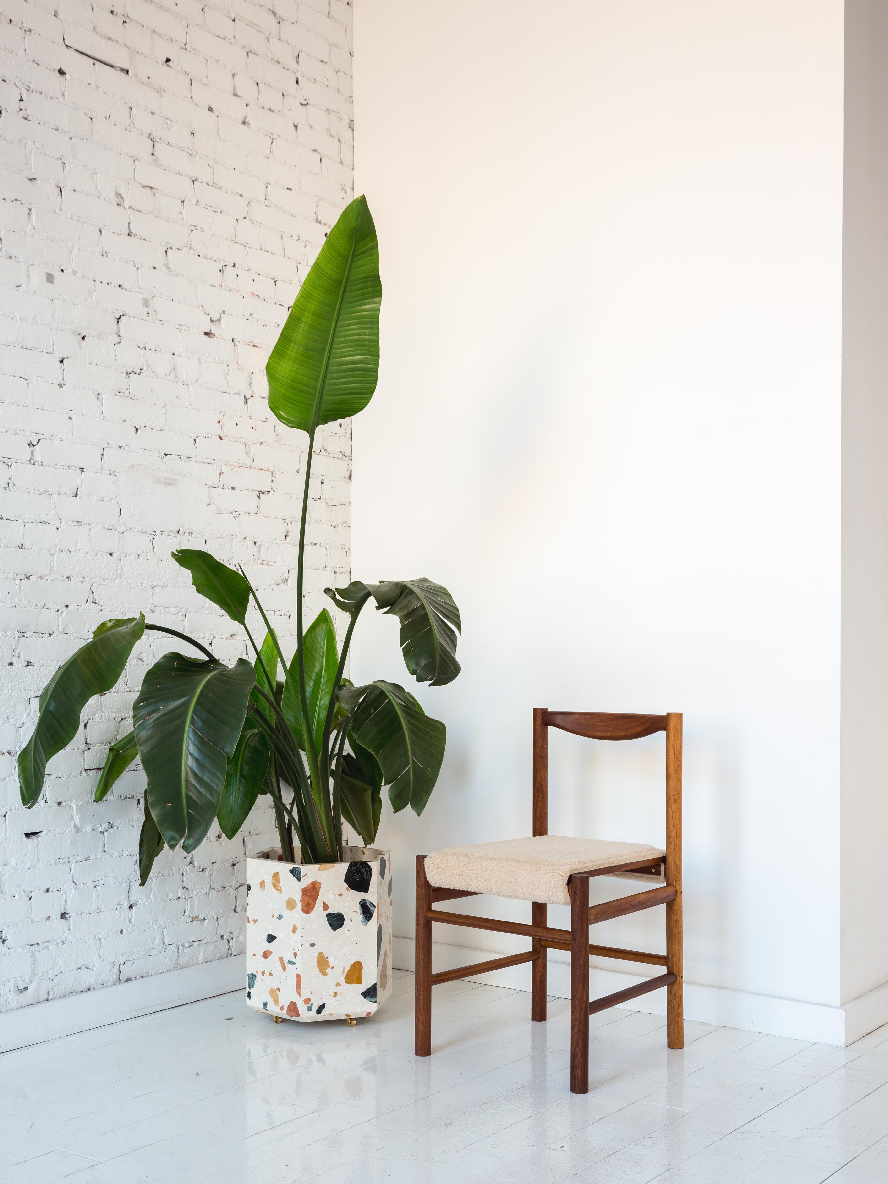 This stone planter is made of the highly coveted Marmoreal, a special aggregate terrazzo material produced by Dzek and designed by Max Lamb. Shown in white Marmoreal and also available in black.

Hexagonal planter is 16 tall and includes small