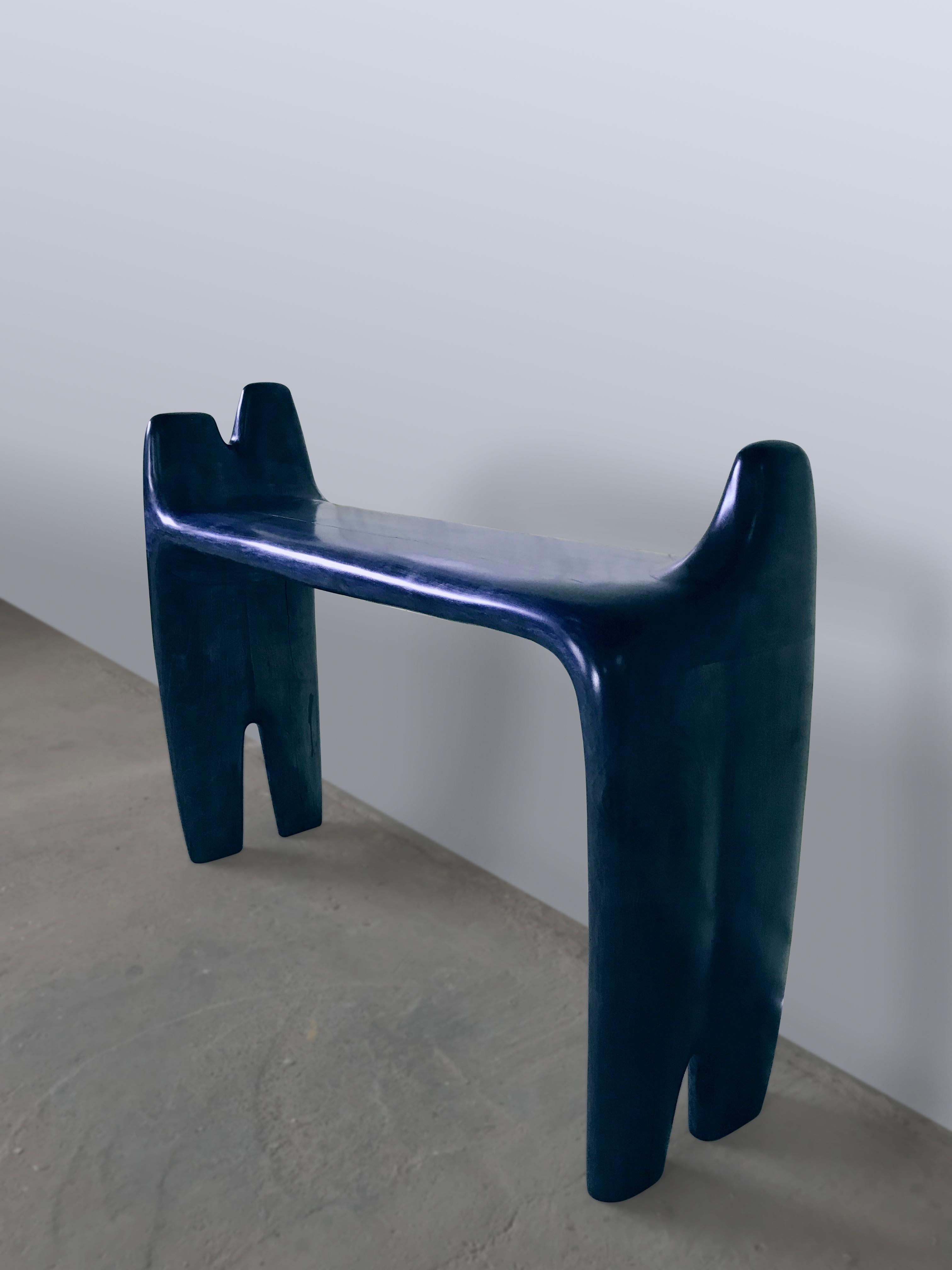 Jordi Sarrate is a product designer and sculptor based in Barcelona, Spain, and the third generation of furniture makers in his family.

The gallery presents 'Jeans' collection sculpted on Iberian walnut wood and finished with indigo blue patina.