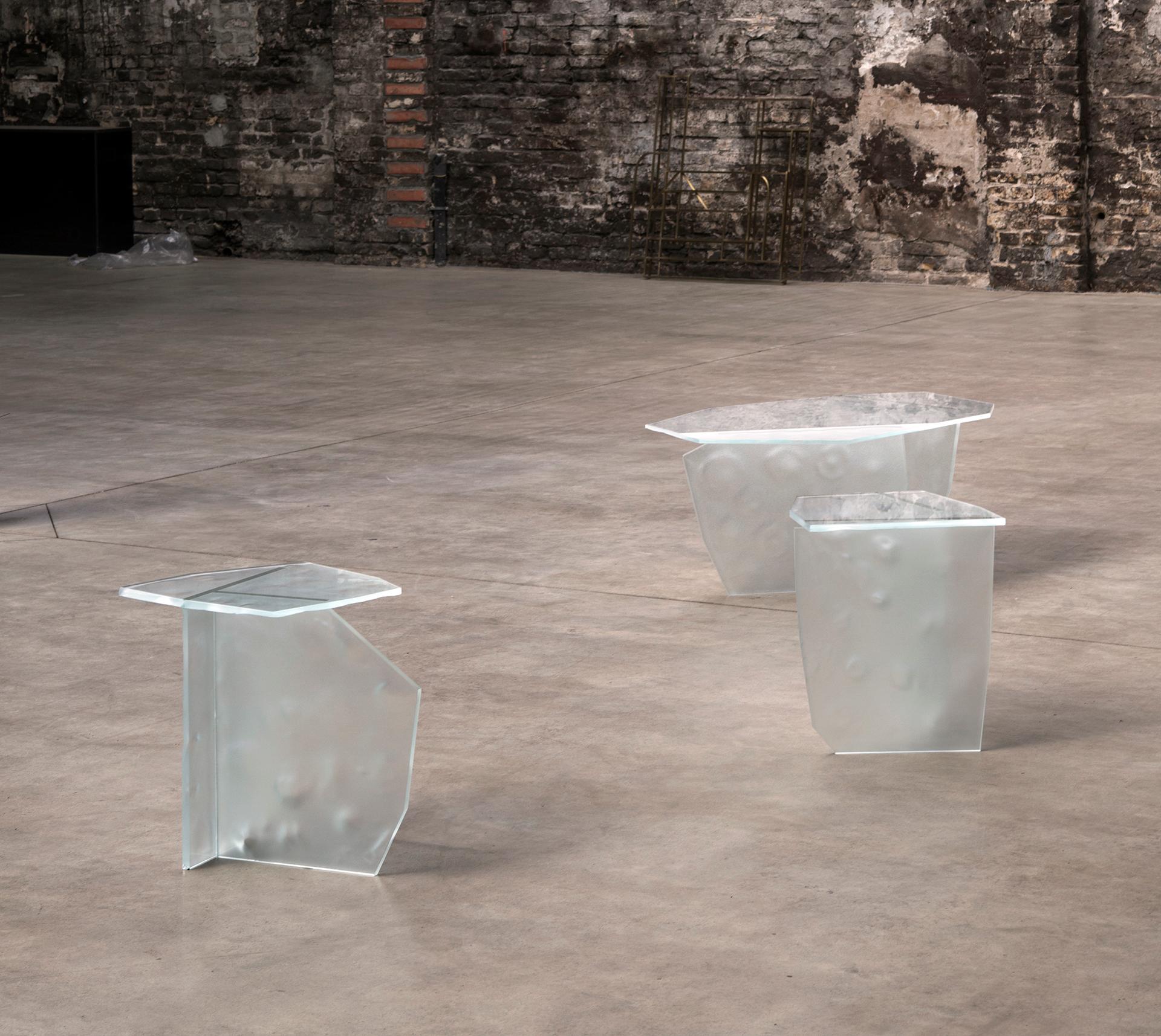 ICED glass tables are a sculptural expression for a moment of transition when water undulates between solid and liquid forms, floating on the surface of moving water.

The surfaces of the white optic glass panes are deep sandblasted by hand and