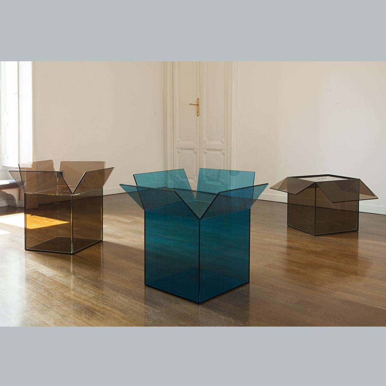 The “Out of the box” side table/box: At once a box, side-table and storage remedy,
this piece takes inspiration from the humble cardboard box, now upgraded and presented as a transparent cube . Having always been on the move and lived back and