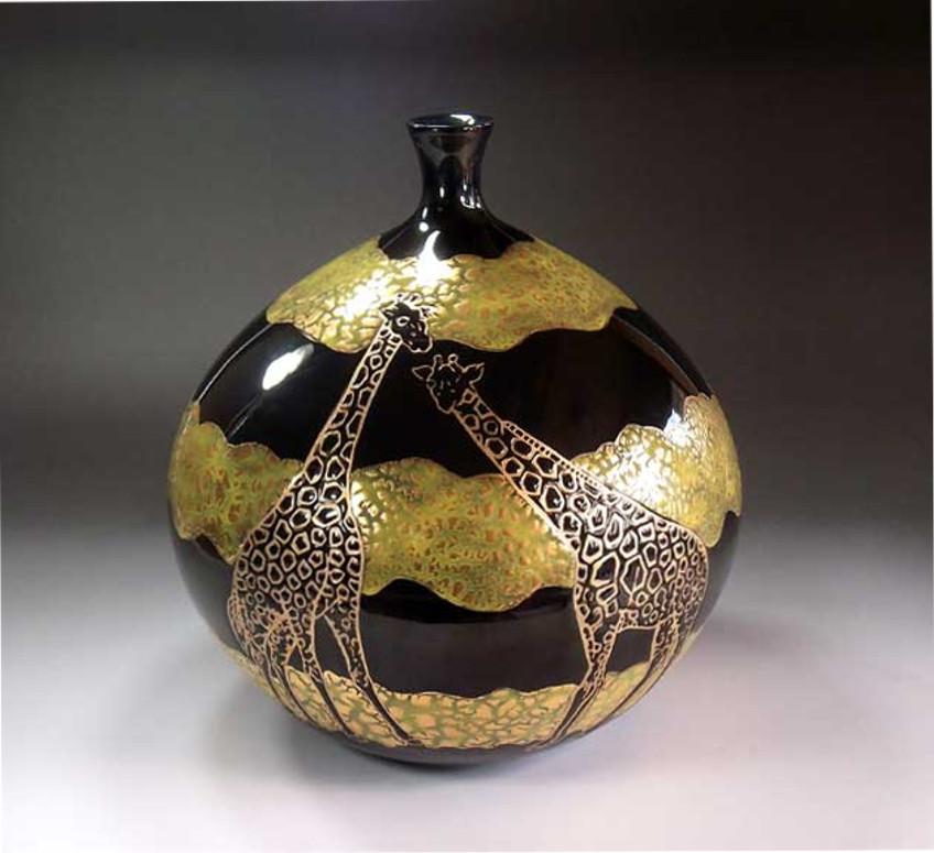 Contemporary Japanese Imari decorative porcelain vase, hand-painted in gold and green on a stunningly shaped ovoid fine porcelain in black to create a transparent surface. 