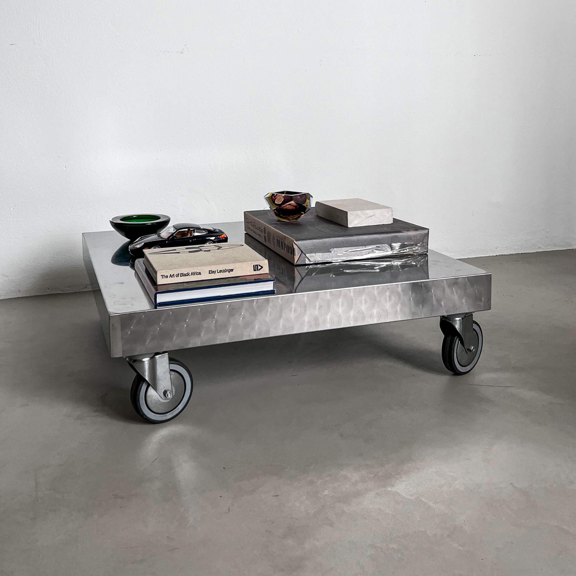 Impressive and attractive stainless steel coffee table with wheels. A sculptural, collectible piece that questions the idea of furniture itself: can a piece that seems to belong in a workshop find a place in a luxury interior? The answer seems to be