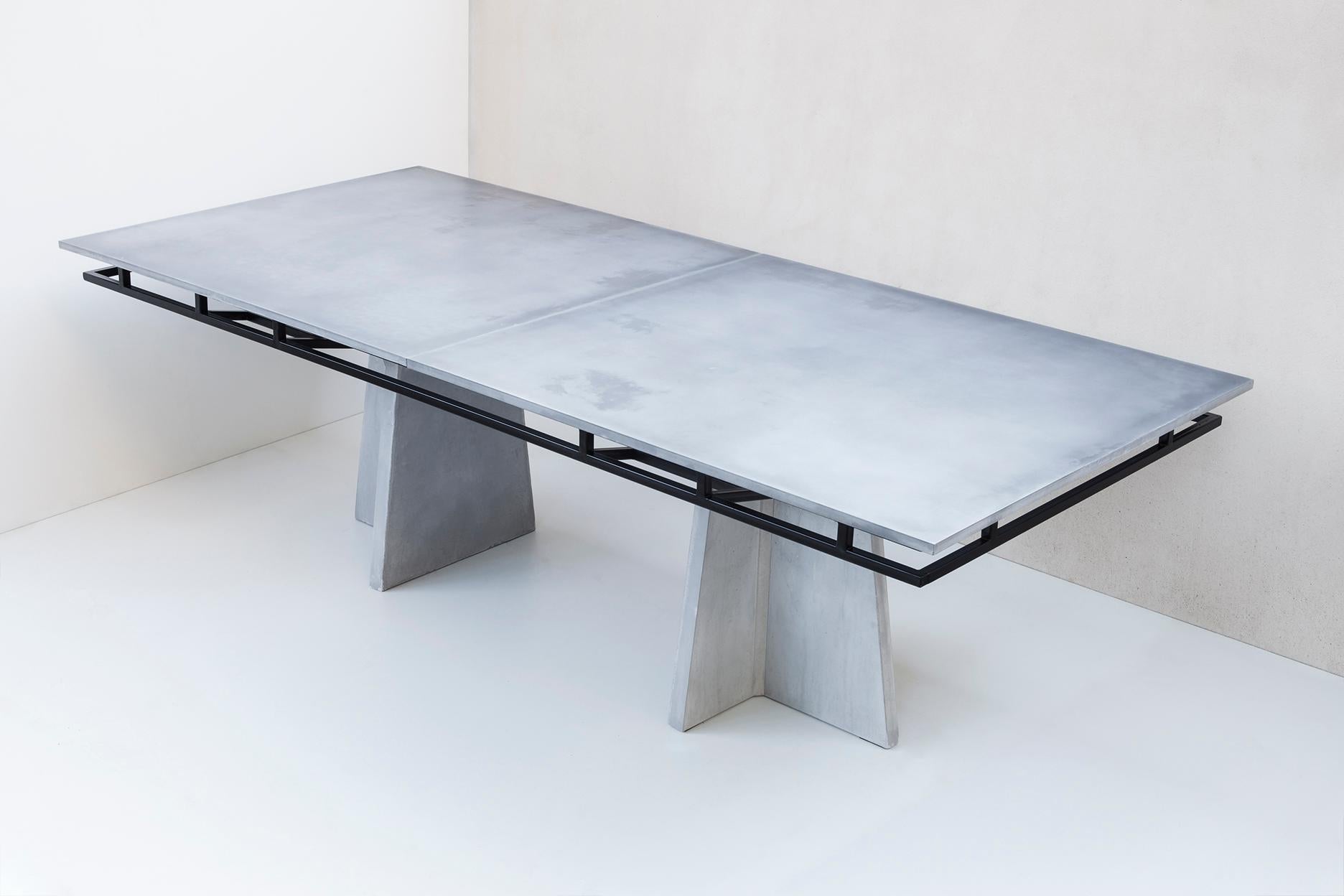 Dining table inspired by the infrastructures aesthetic. Concrete legs support a black painted structure that supports concrete plates. 
To use infrastructures as a design inspiration was led by the fascination in this kind of projects and to refer