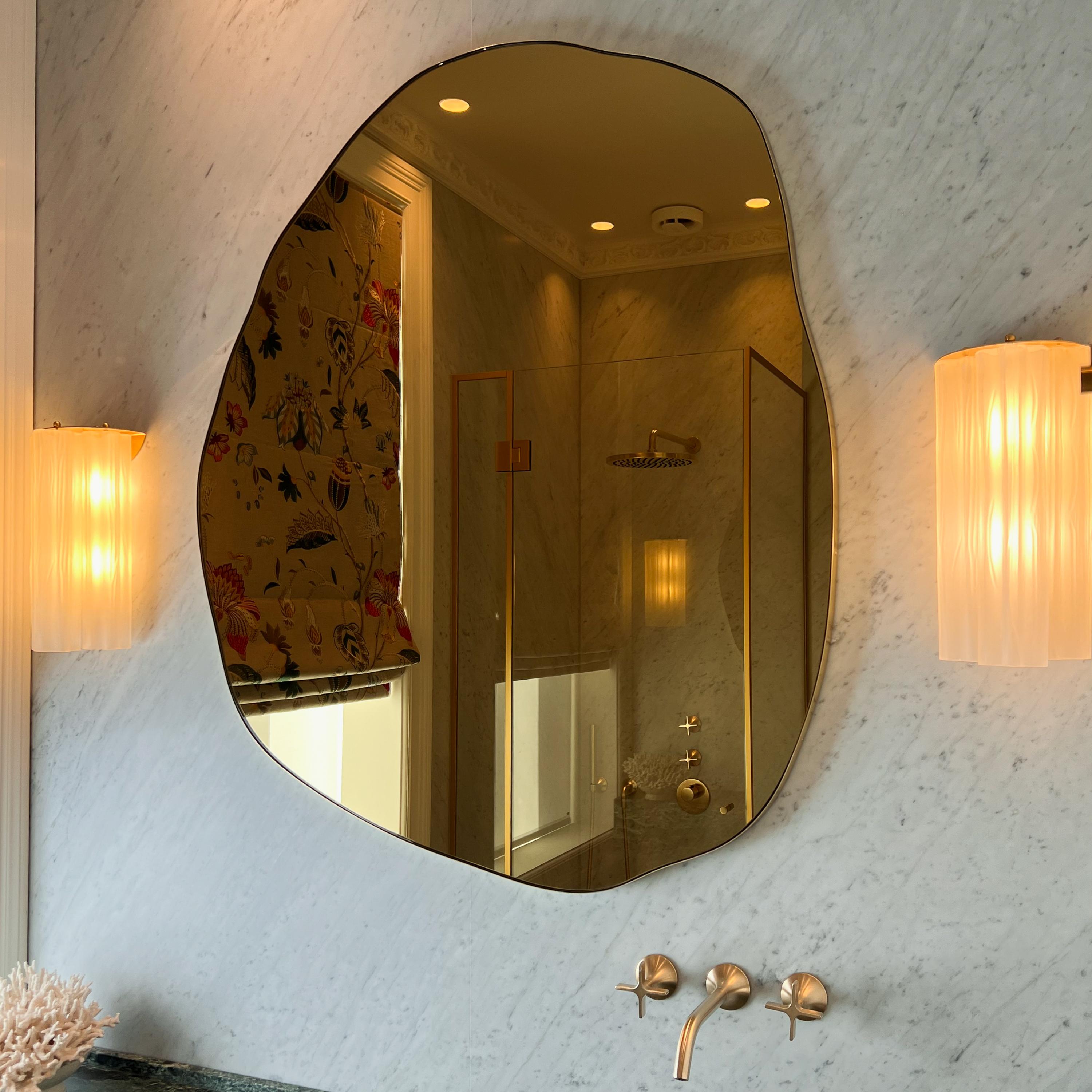 Contemporary organic shape freeform mirror with a solid polished brass frame. Designed and made in London, UK. This mirror is fully customisable to suit the specific requirements of your interior.

Dimensions 120cm x 110cm x 1.8cm / 47.24in x 43.3in
