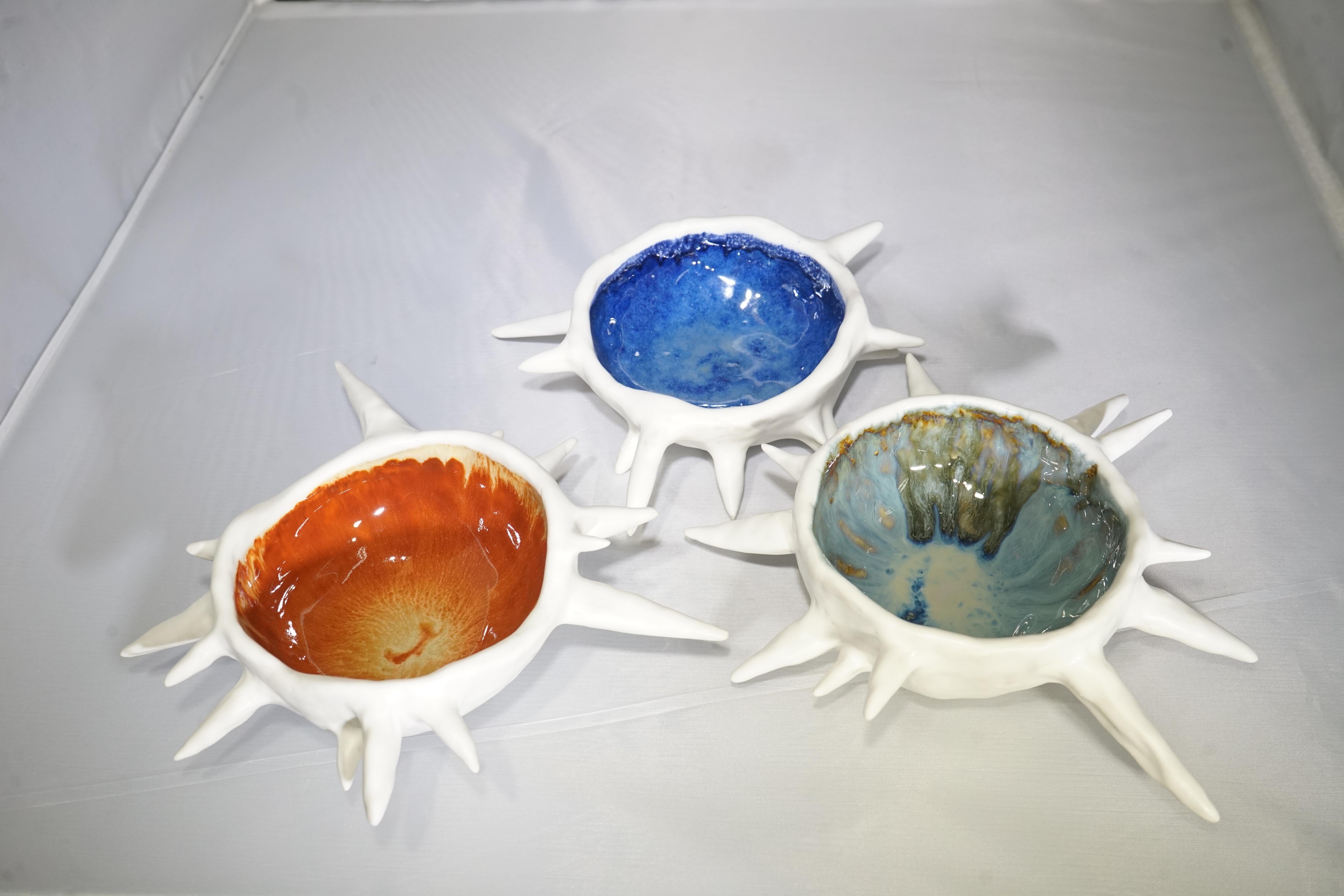 Contemporary Isabelle Poupinel Paris sea urchin shaped bowl featuring multi-color porcelain enamels. Vintage-looking urchins. The marina blue, terracotta orange, glittery pinky-yellow enamels are evocative of the Italian Riviera of the 1930s. These