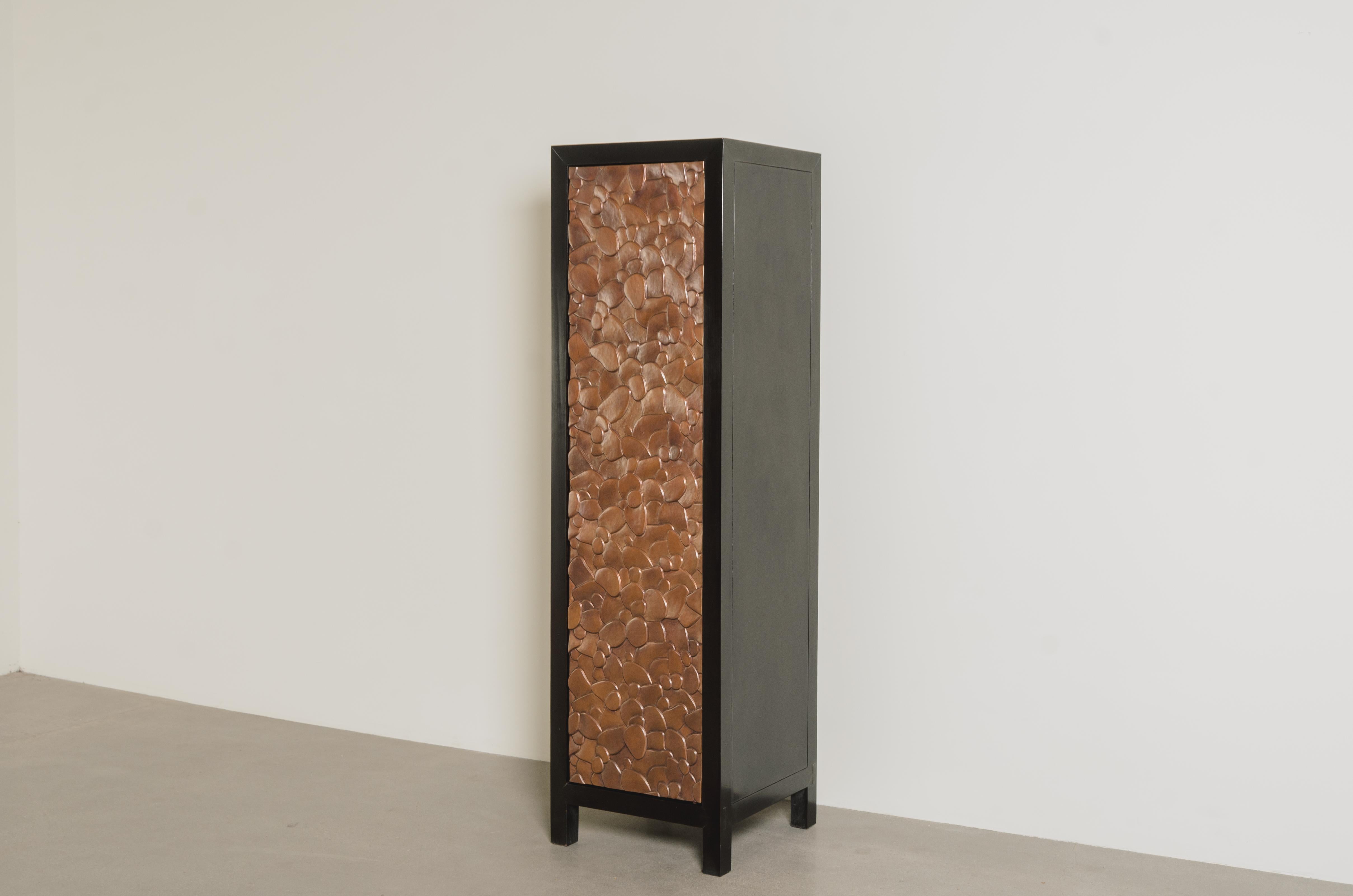 Isola Design Narrow Cabinet
Antique Copper Doors
Hand Repoussé
Elm Wood
4 Shelves
Limited Edition
Each piece is individually crafted and is unique. 

Repoussé is the traditional art of hand-hammering decorative relief onto sheet metal. The technique