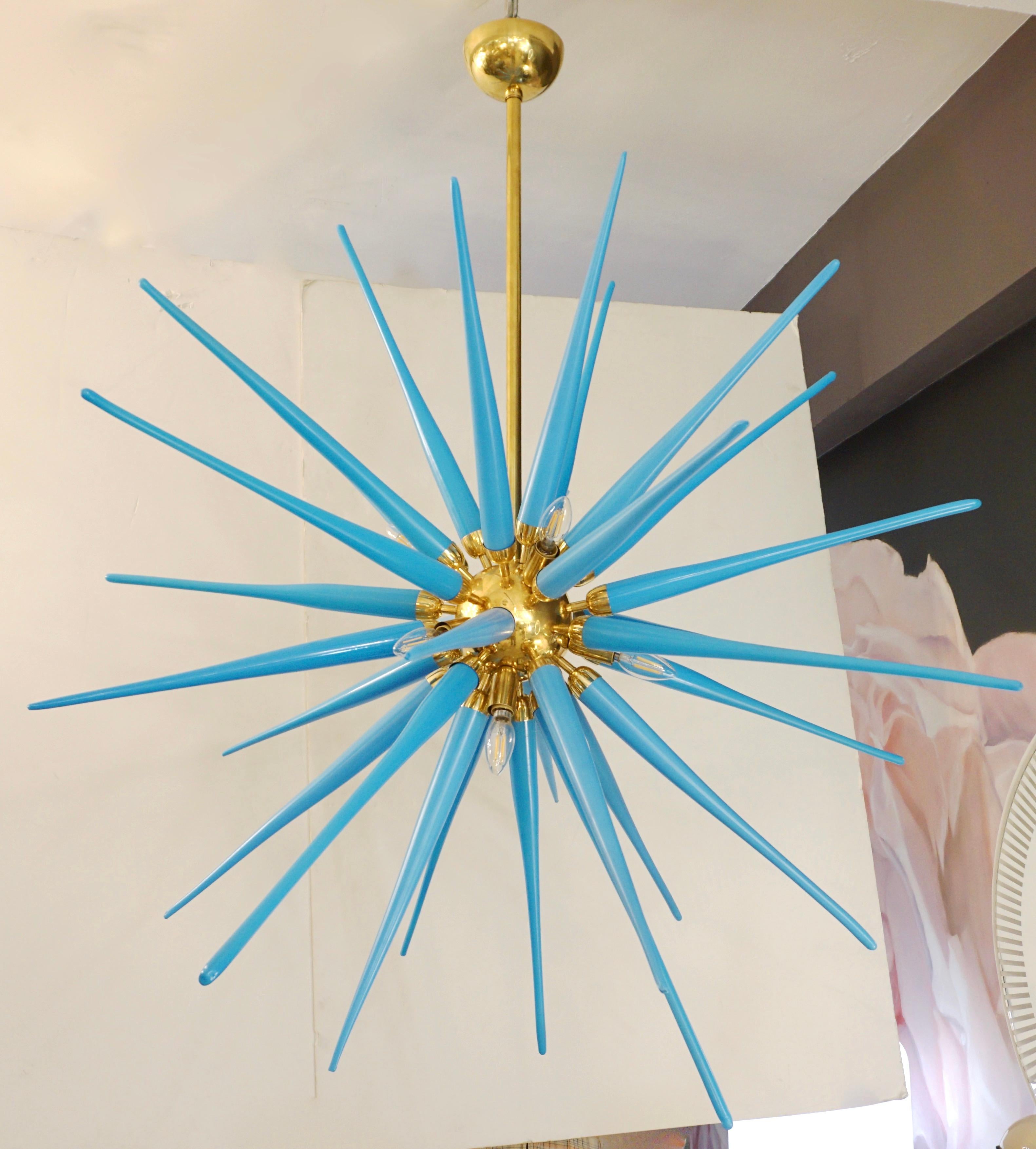 A pair available now - contemporary bespoke creation realized for Cosulich Interiors & Antiques NYC, entirely handcrafted in Murano, Italy of minimalist clean design. The polished brass handmade structure supports 30 Spikes realized in azure