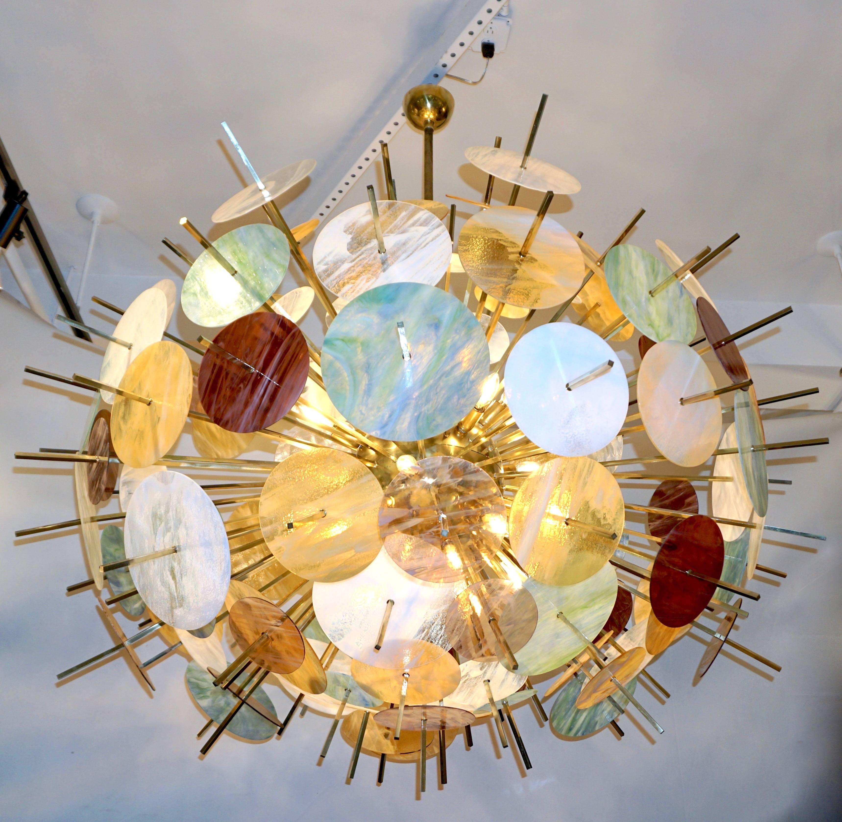 Contemporary Italian exclusive Sputnik chandelier of grand size, entirely handcrafted, an enticing modern oval design with a brass structure composed of a central core supporting jutting out brass baguettes with an interesting square section, each