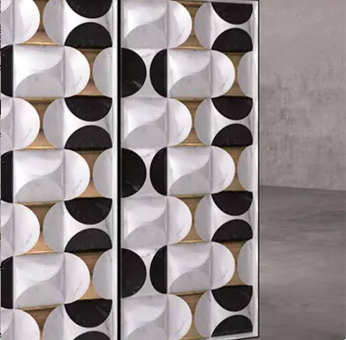 This contemporary cabinet is crafted in Italy in white calacatta marble and Nero Marquina marble with polished brass details all inspired by ancient art of origami. The combination of different materials that can be seen reproduce the effect of silk