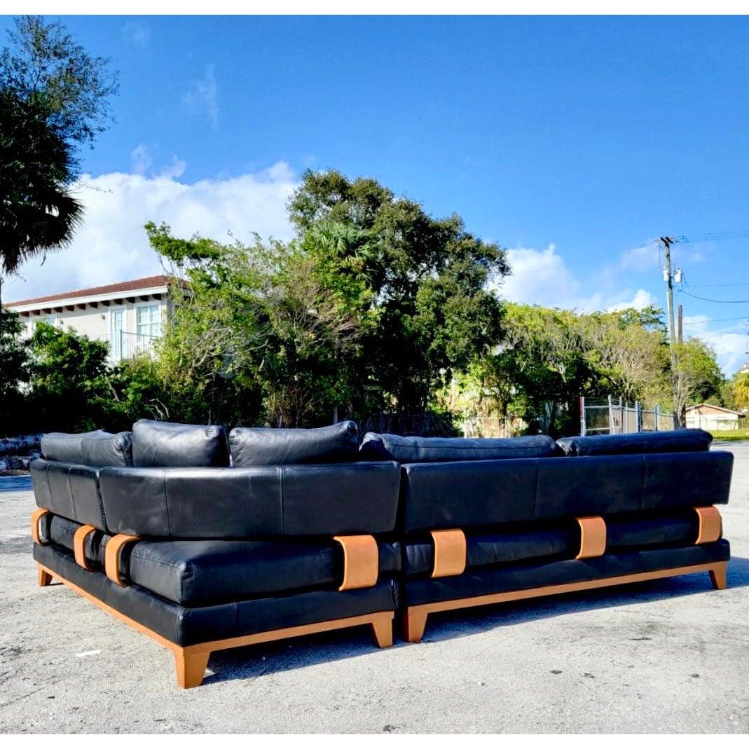 Fantastic Contemporary black leather Sectional sofa. Beautiful wood frame with deep seats and cushions built for comfort. No detail was spared. A modern design with all the comfort of a regular sectional. Made in Italy. Acquired from a Palm Beach
