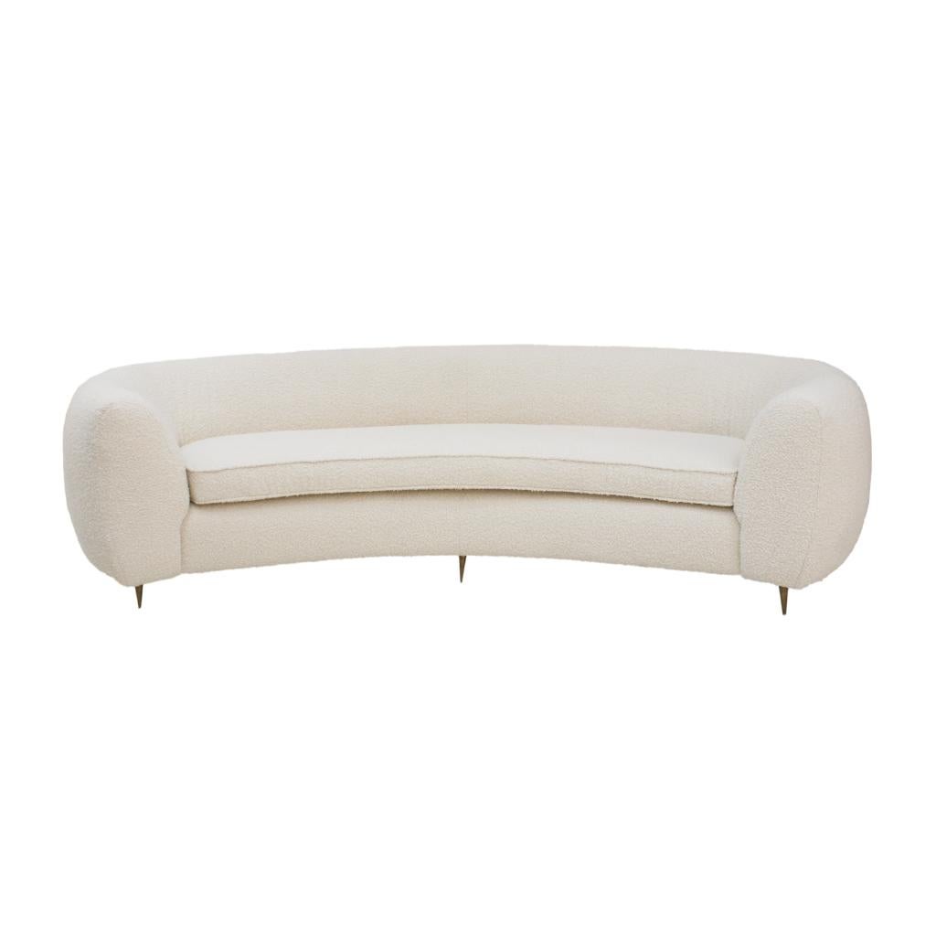 Curved four-seat sofa with solid wooden structure and four brass legs. Upholstery in white bouclé wool. Italian manufacture.

Our main target is customer satisfaction, so we include in the price for this item professional and custom made packing.