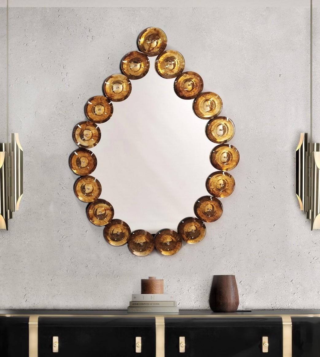 A fun decorative object that brings light and color in your interior! Contemporary Italian Custom Murano Glass Disk Mirror in a Modern Pearl Drop Shape Design, the mirror frame is composed of 19 Murano glass round elements of amber color with a