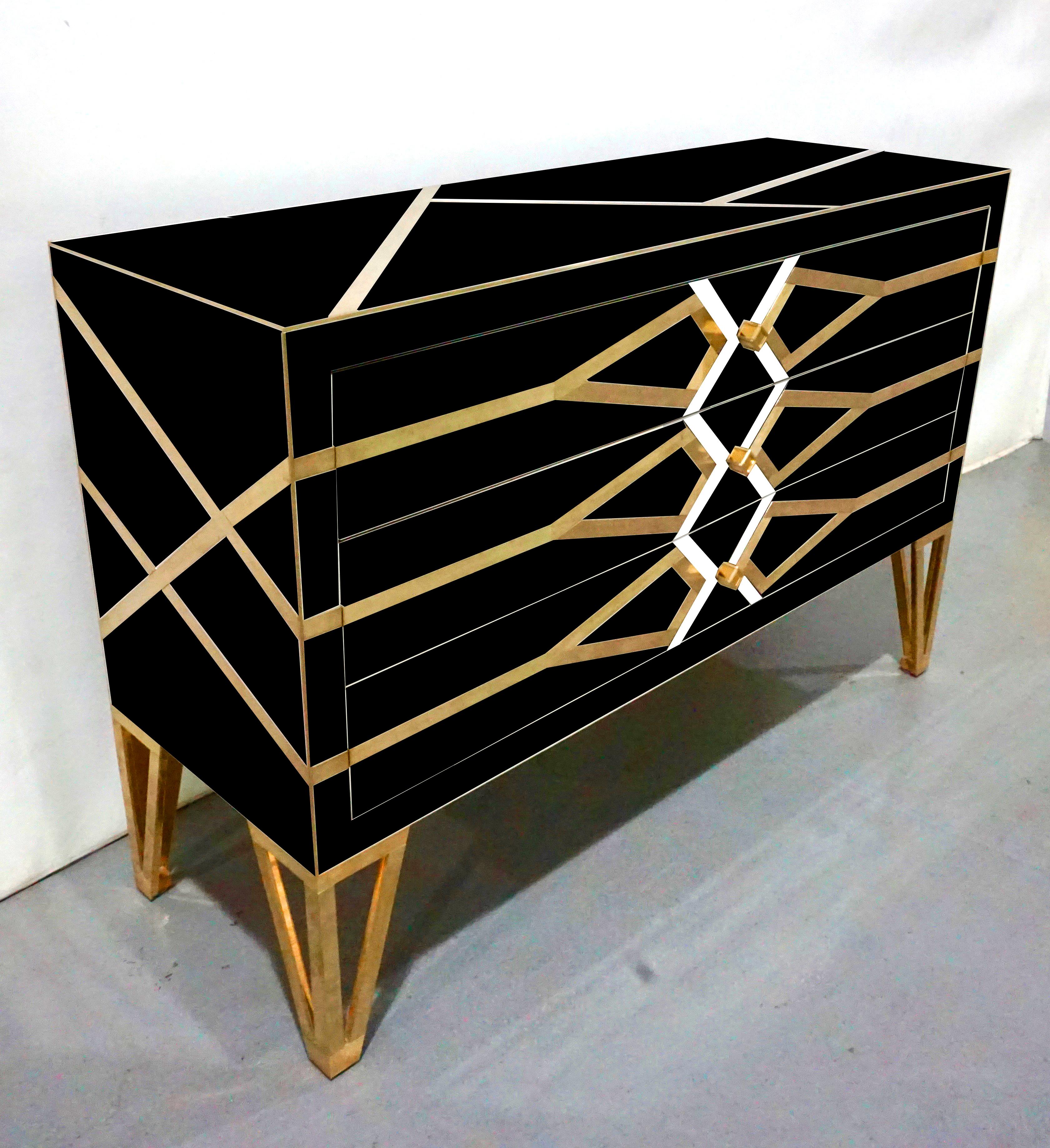 Italian three-drawer contemporary customizable commode, entirely handmade, exclusive modern Art Deco design by Cosulich Interiors, showing high quality and elegance of execution: the surround in black opaline glass is decorated with a geometric